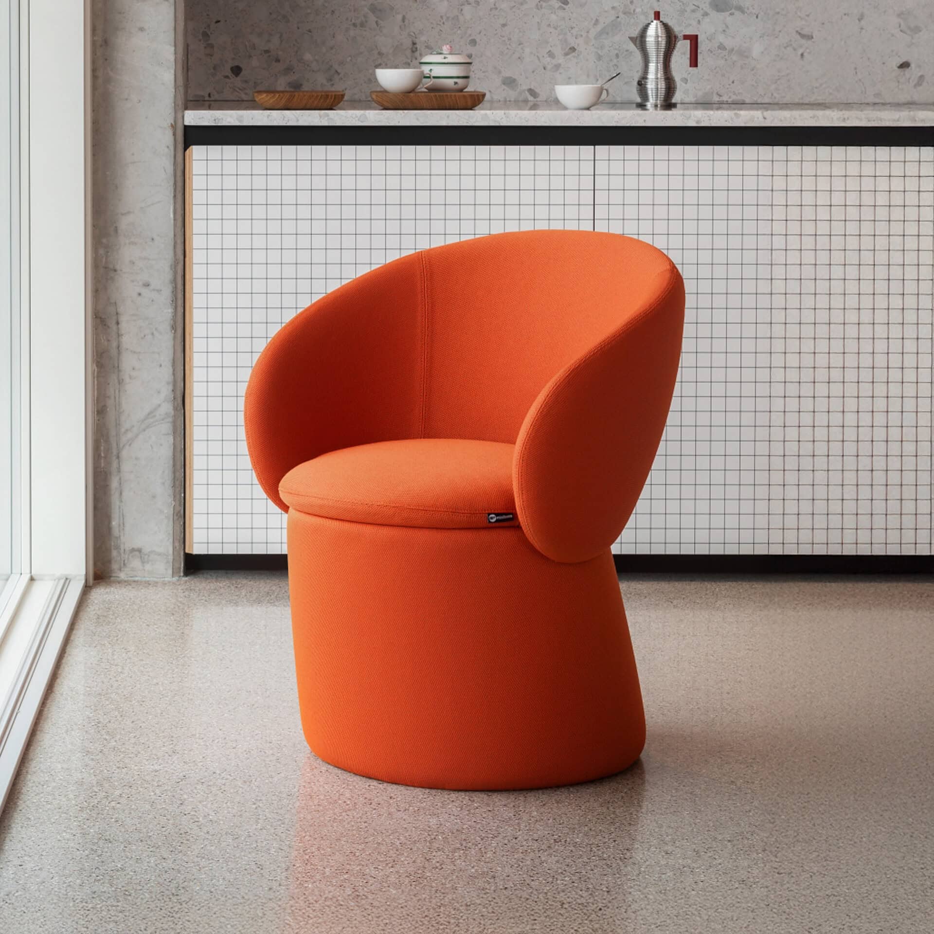 Modern orange Nebula Monaca dining chair with rounded backrest.