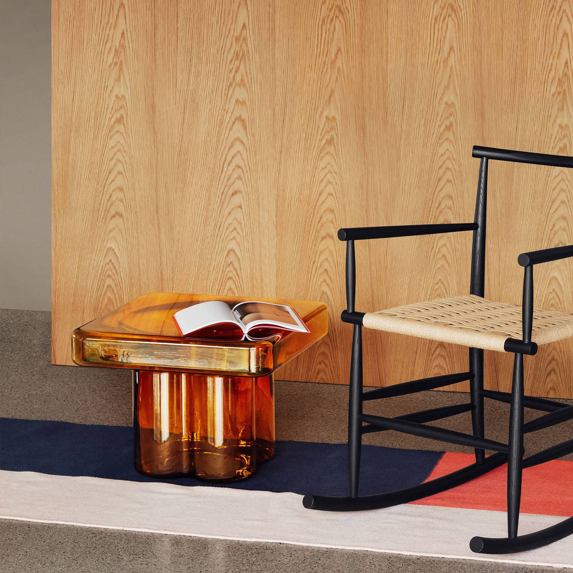 Amber Soda Square Coffee Table paired with a wooden chair and rug in a contemporary interior setting.