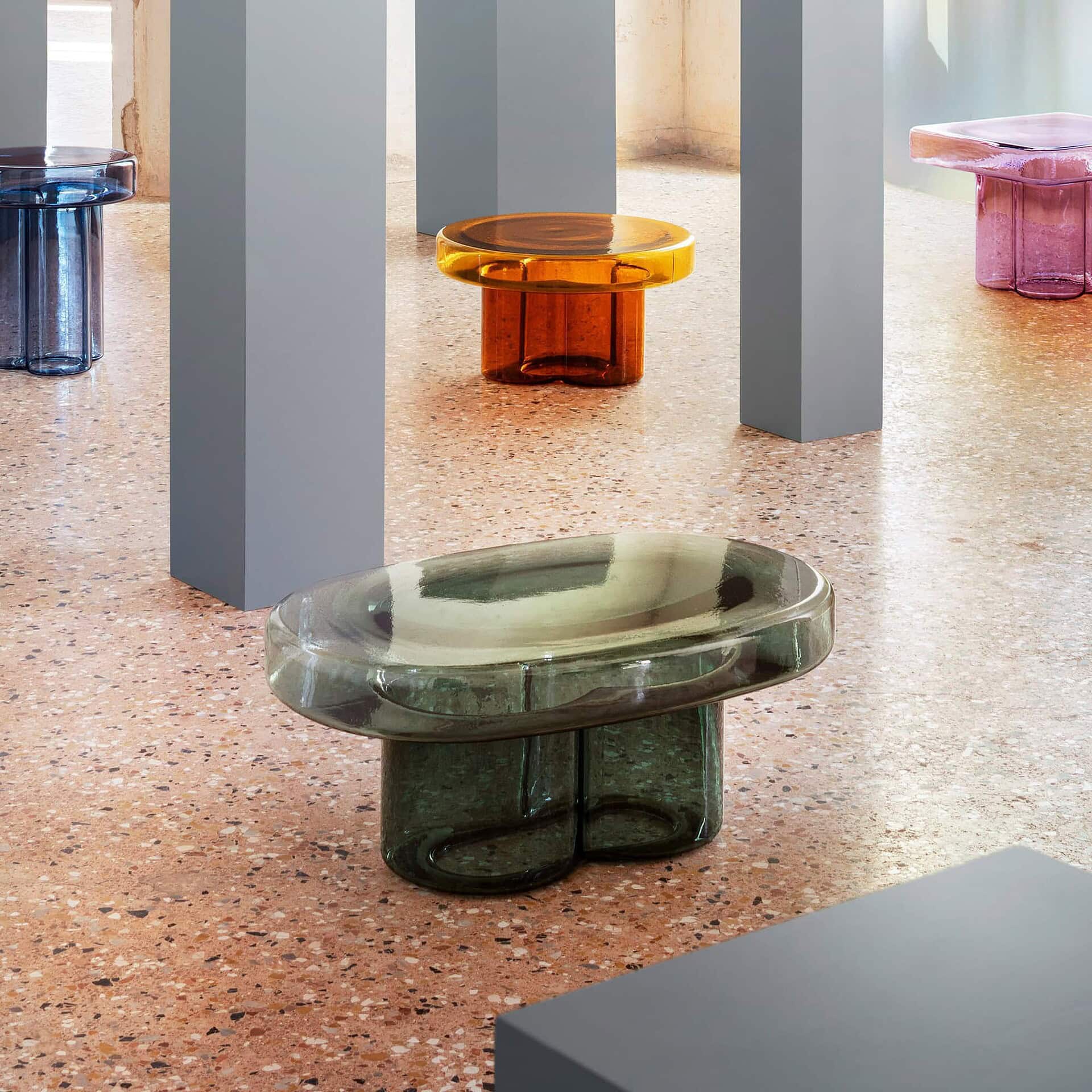 Collection of Soda Oval Coffee Tables in Amber, Green, and Amethyst finishes displayed together.