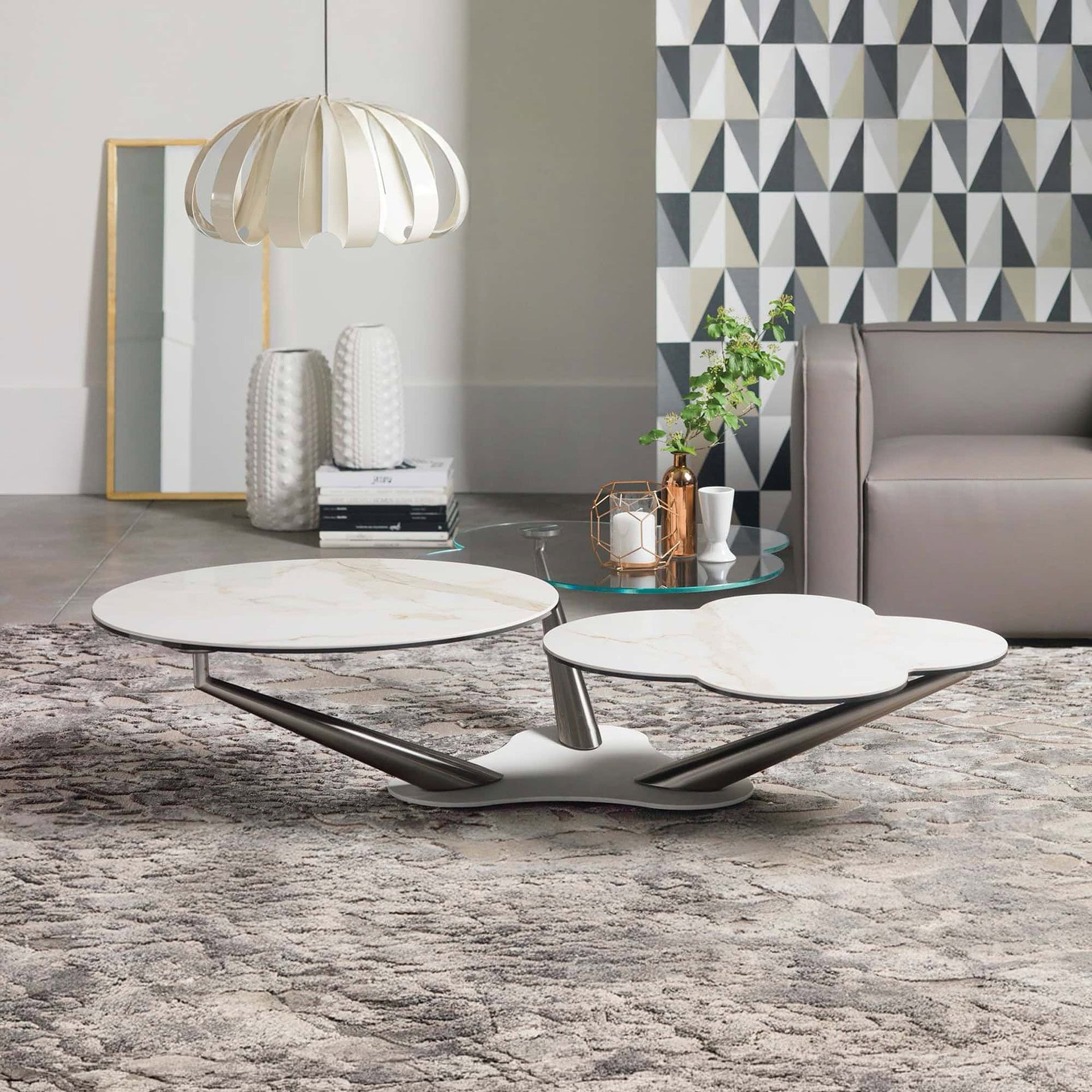 Contemporary nesting coffee tables with marble tops and sleek metal bases in a stylish living room.