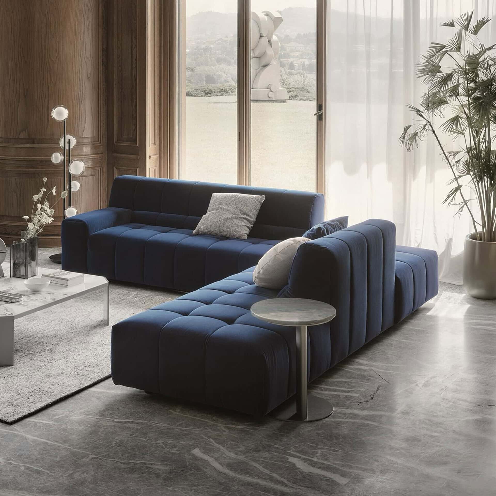Modern Bric sectional sofa in navy blue with plush cushions.