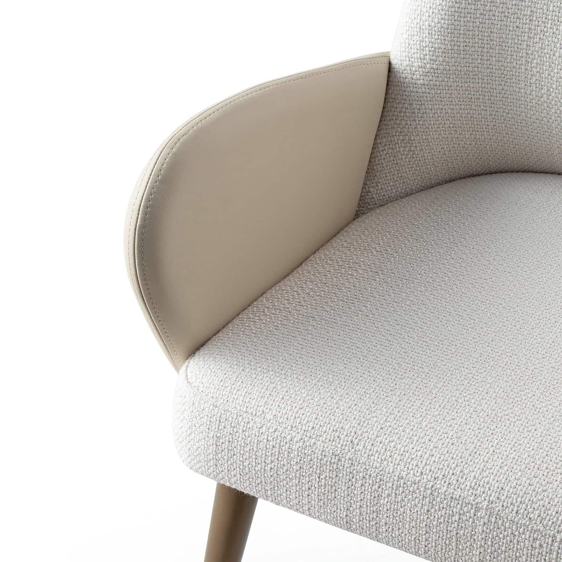 Sofa with beige fabric upholstery and armrest, modern furniture design.