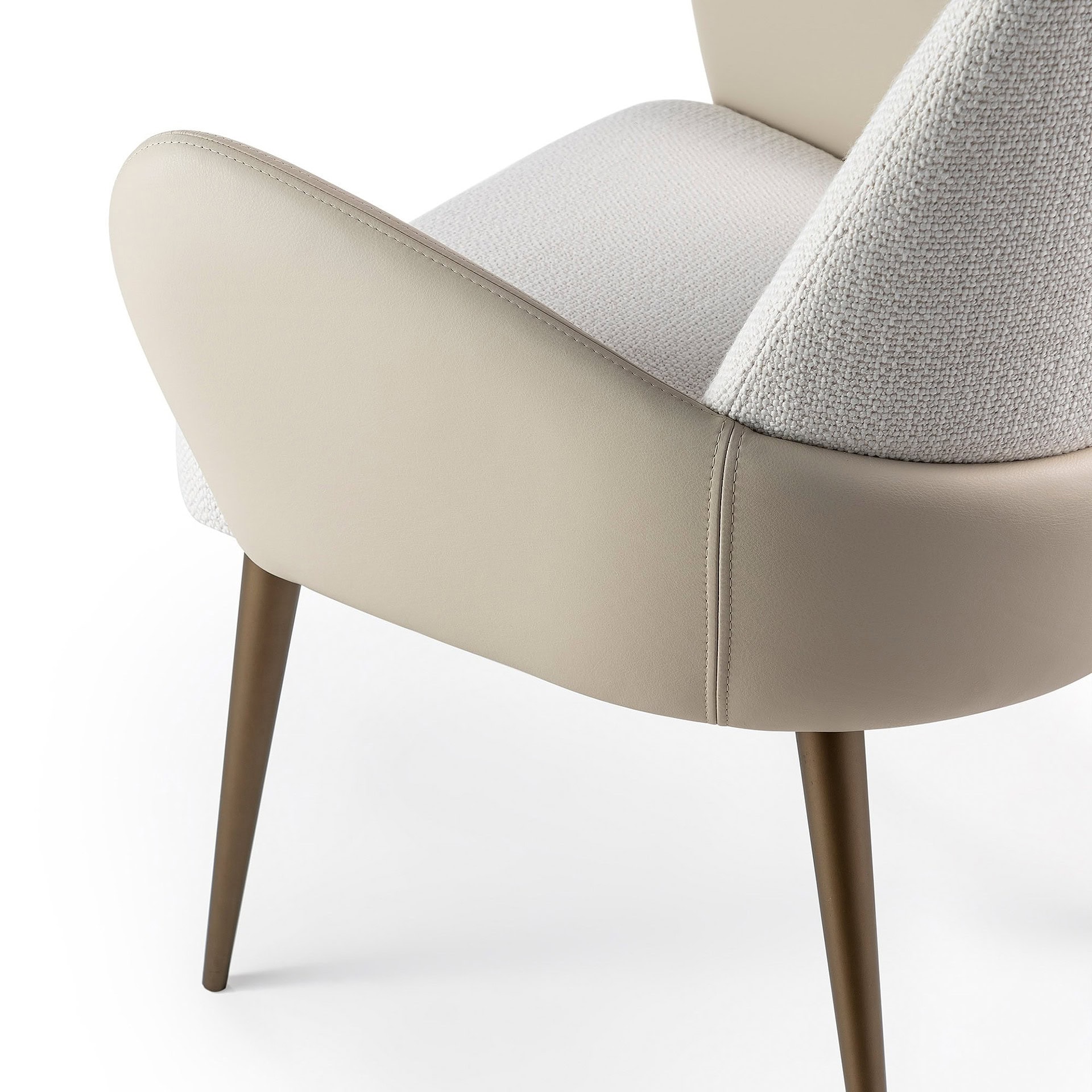 Luxurious beige upholstered armchair with tapered wooden legs, ideal for modern living spaces.