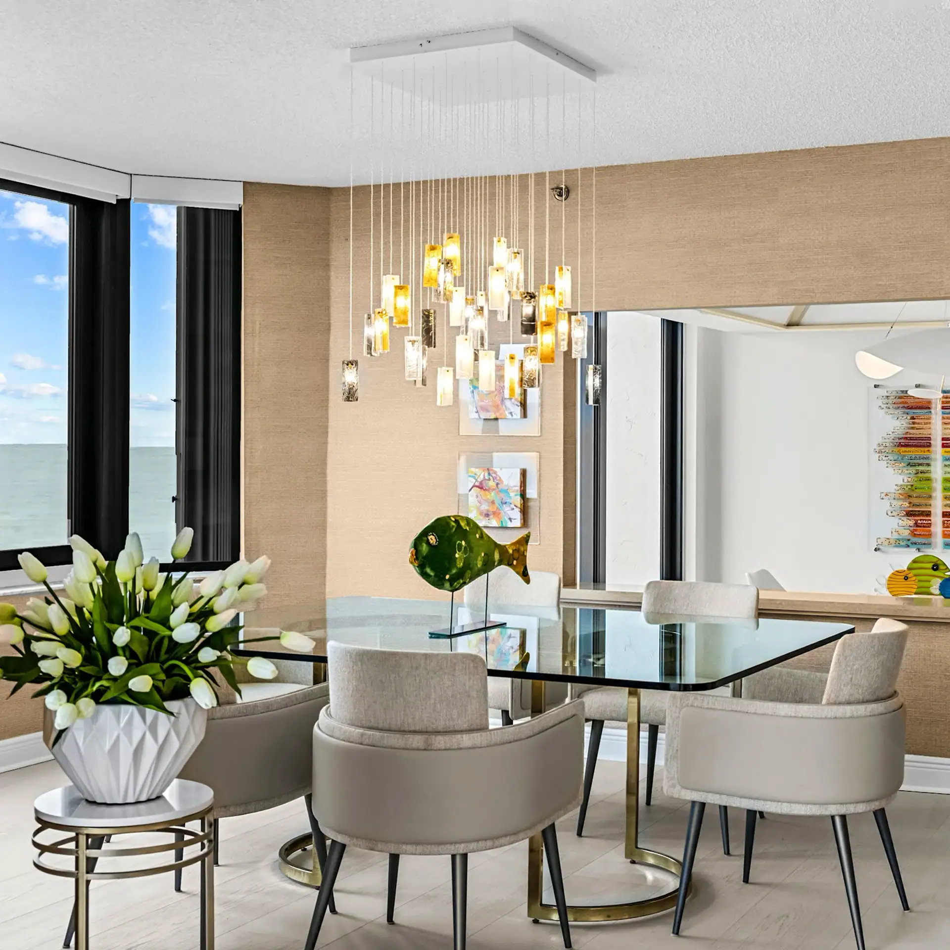 Elegant Modern Dining Room with Natural Light Elegant modern dining room featuring a glass table, plush chairs, and contemporary lighting fixtures.