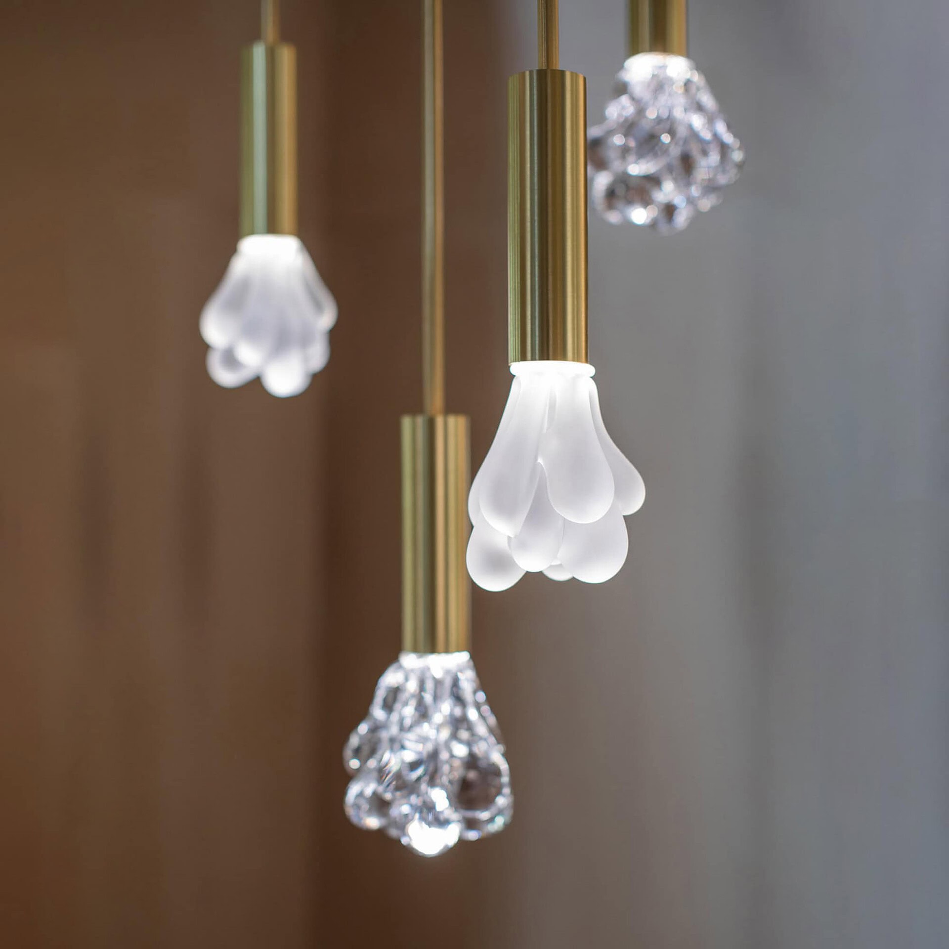 Modern SkLO pendant lights with glass and brass finishes.