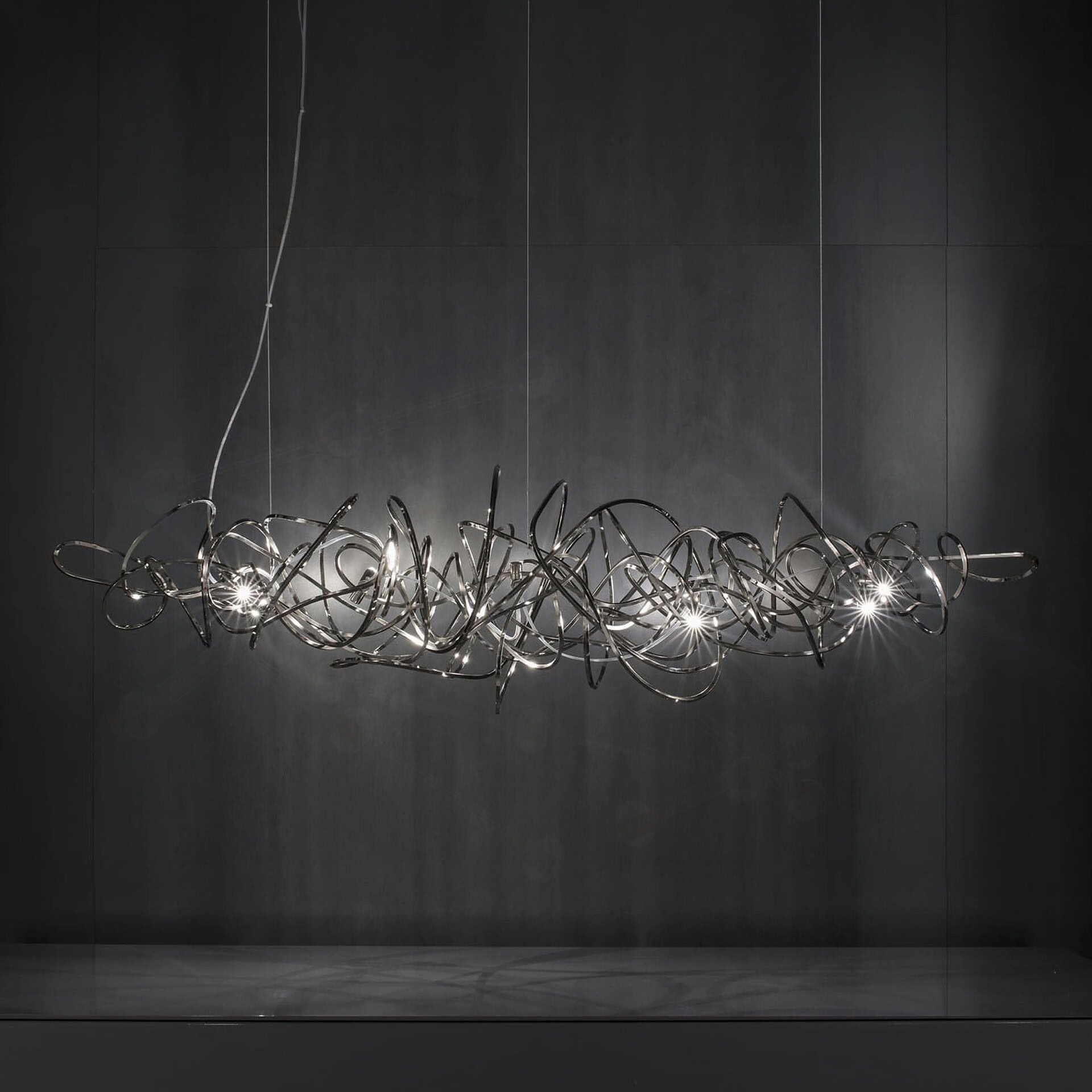 Modern sculptural chandelier with intertwined metal loops and integrated lighting.