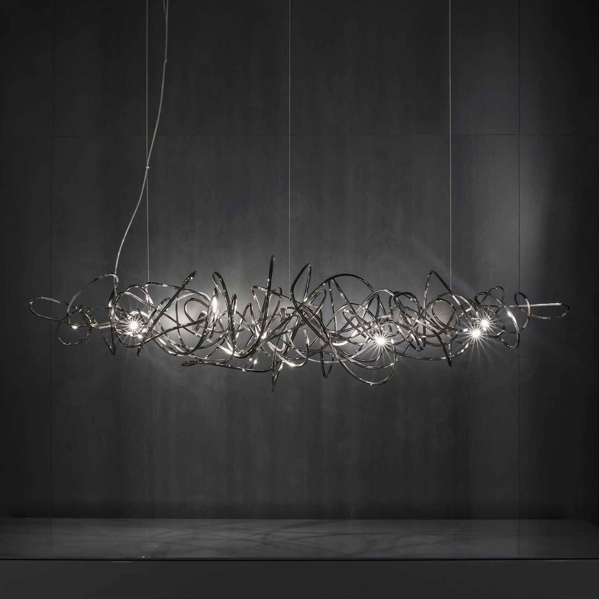 Elegant Sklar Furnishings chandelier featuring a complex metal sculpture design.