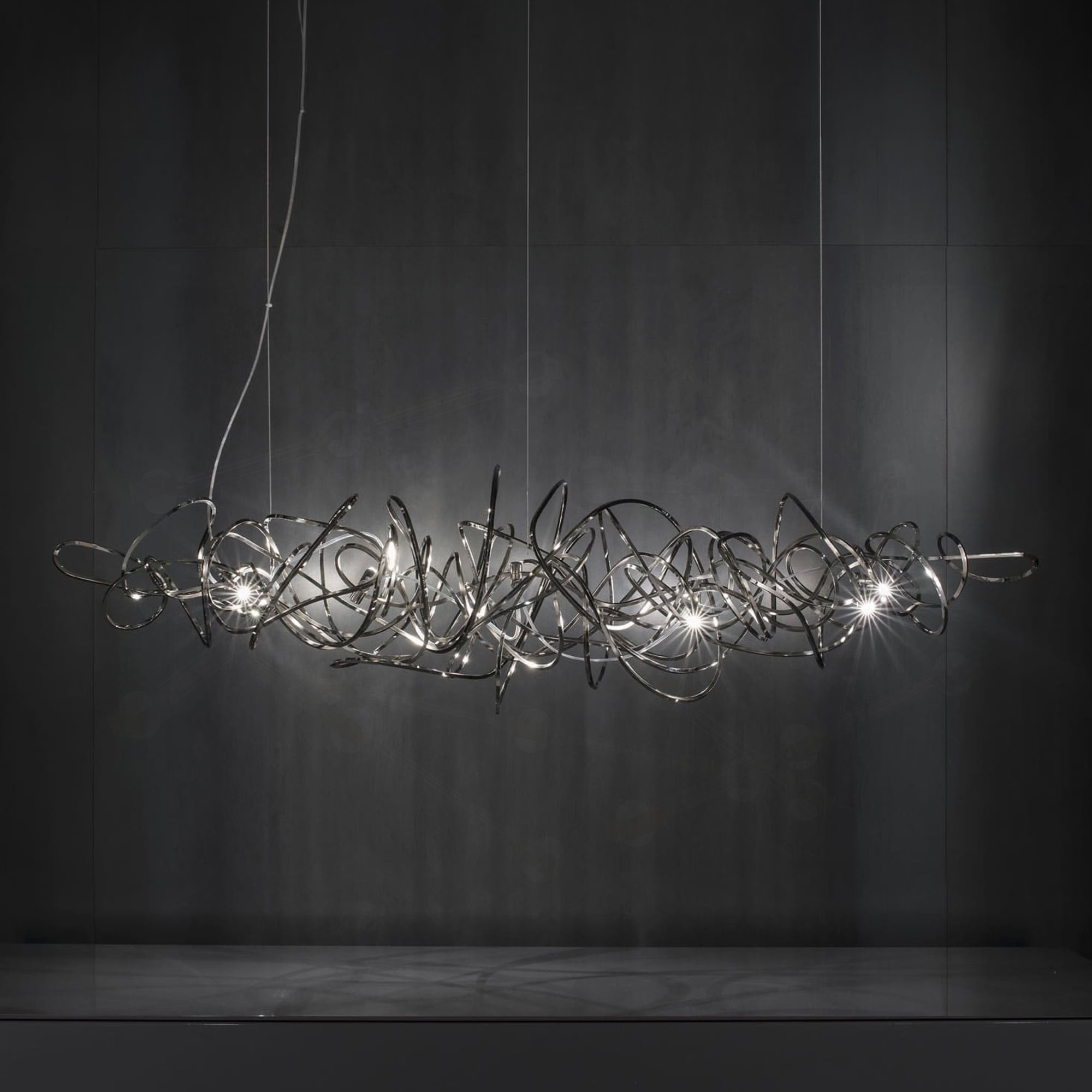 Elegant Sklar Furnishings chandelier featuring a complex metal sculpture design.
