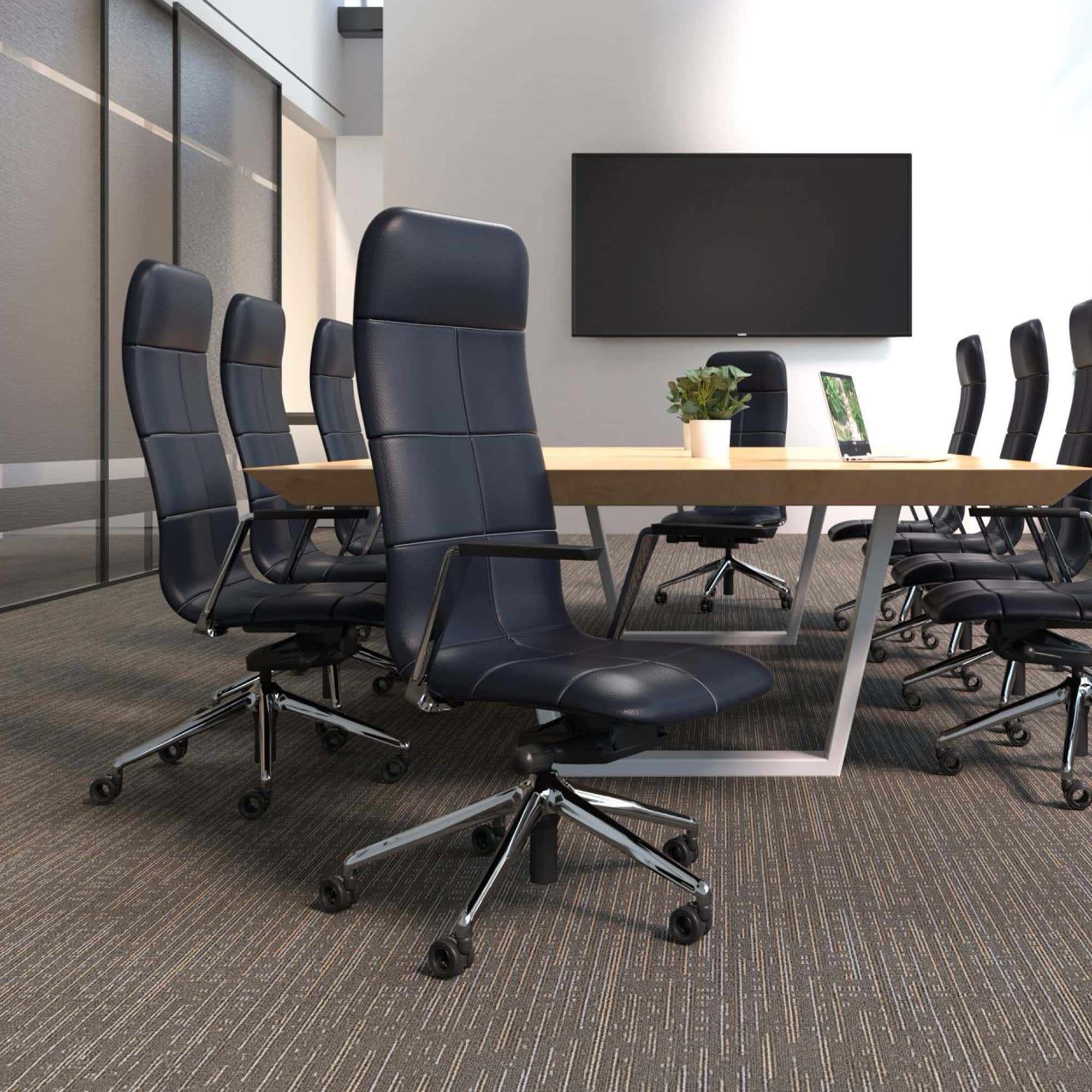 Conference room with black leather office chairs and a large meeting table.