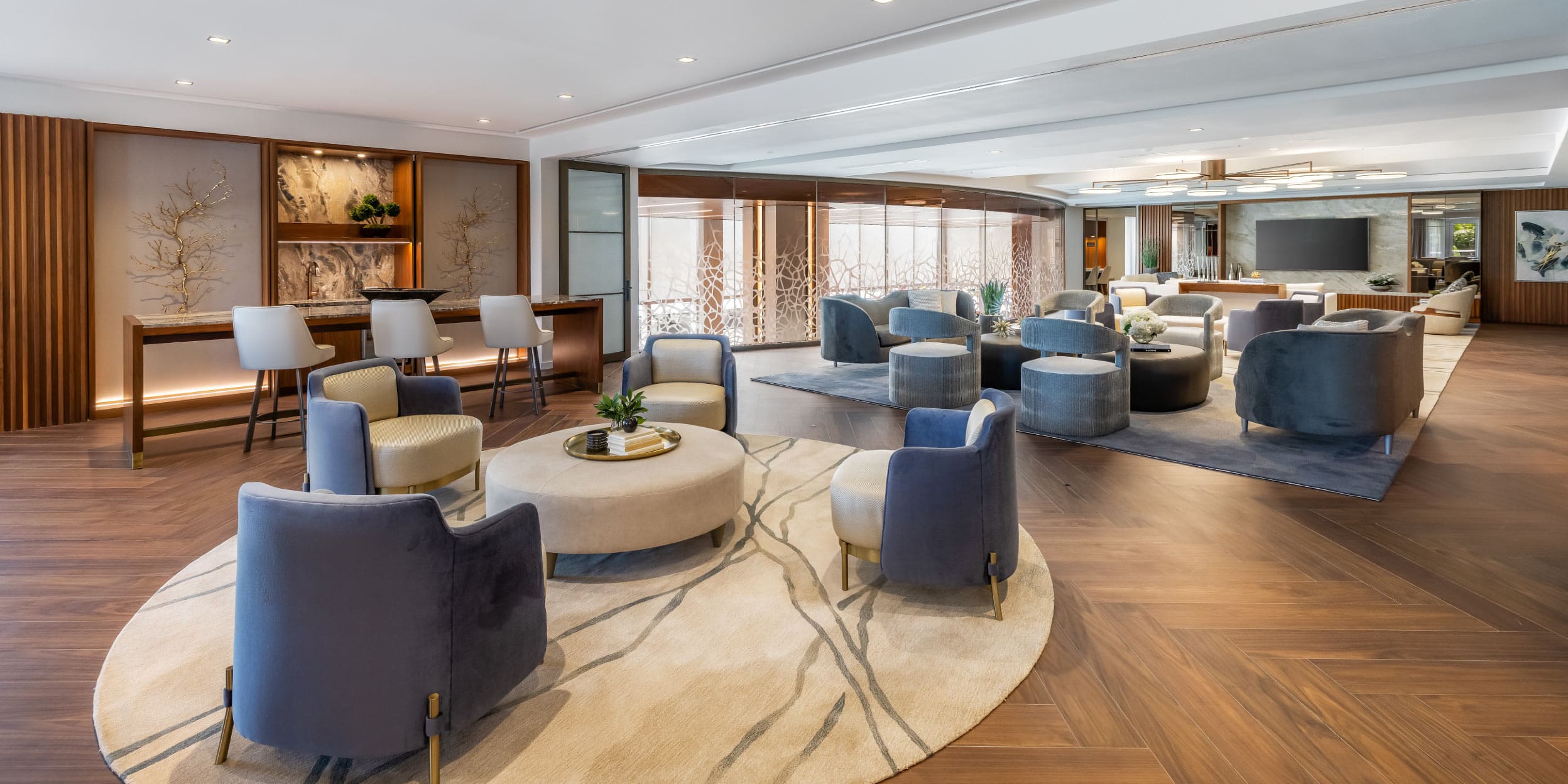 a room with a large round area with chairs and tables