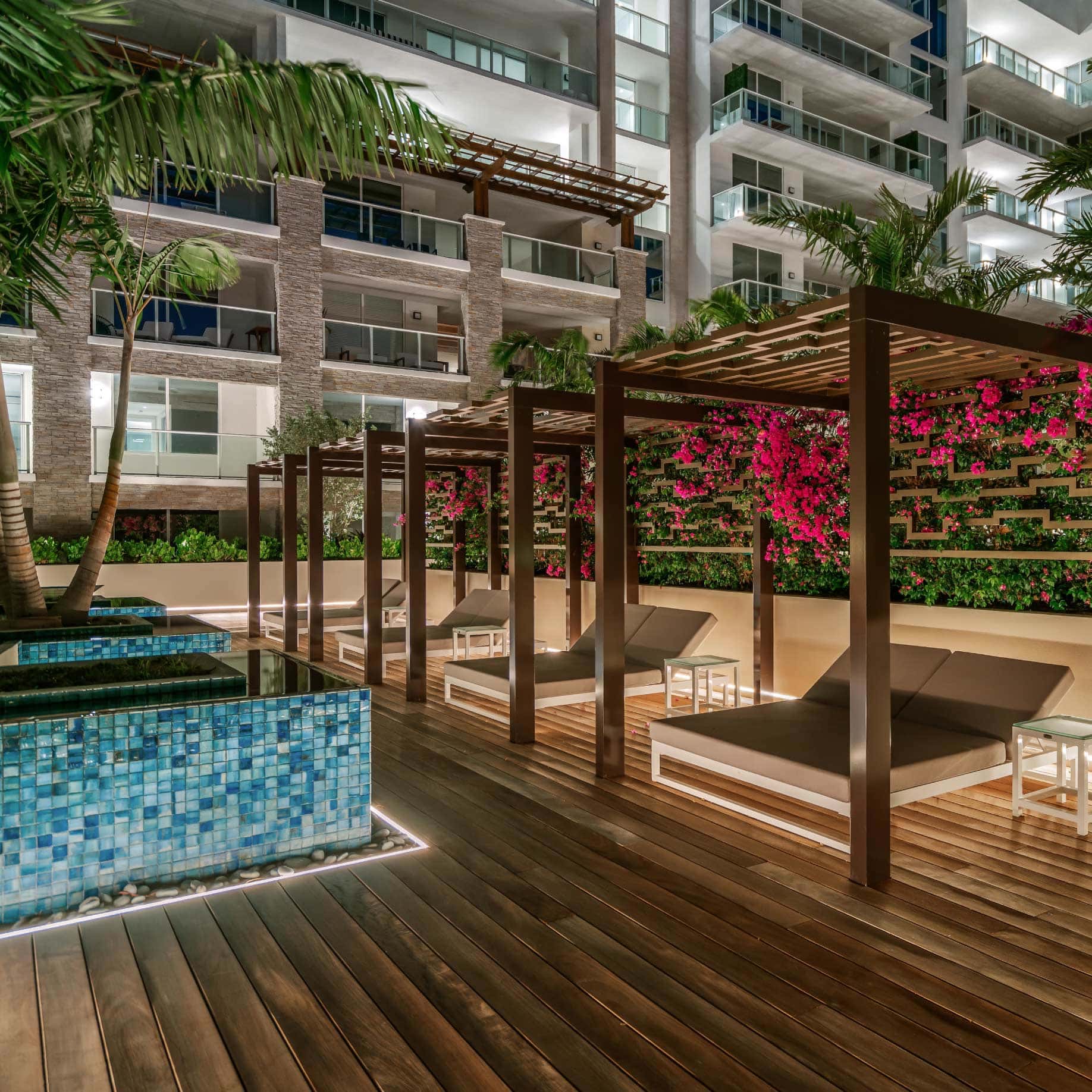 a deck with a pool and lounge chairs