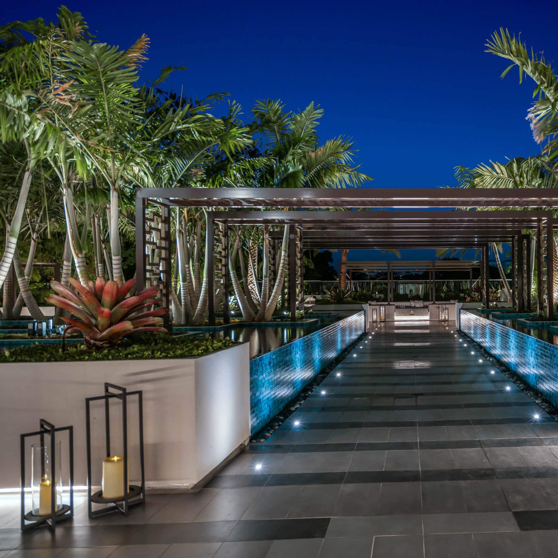 a walkway with a pool and a walkway with a walkway and trees