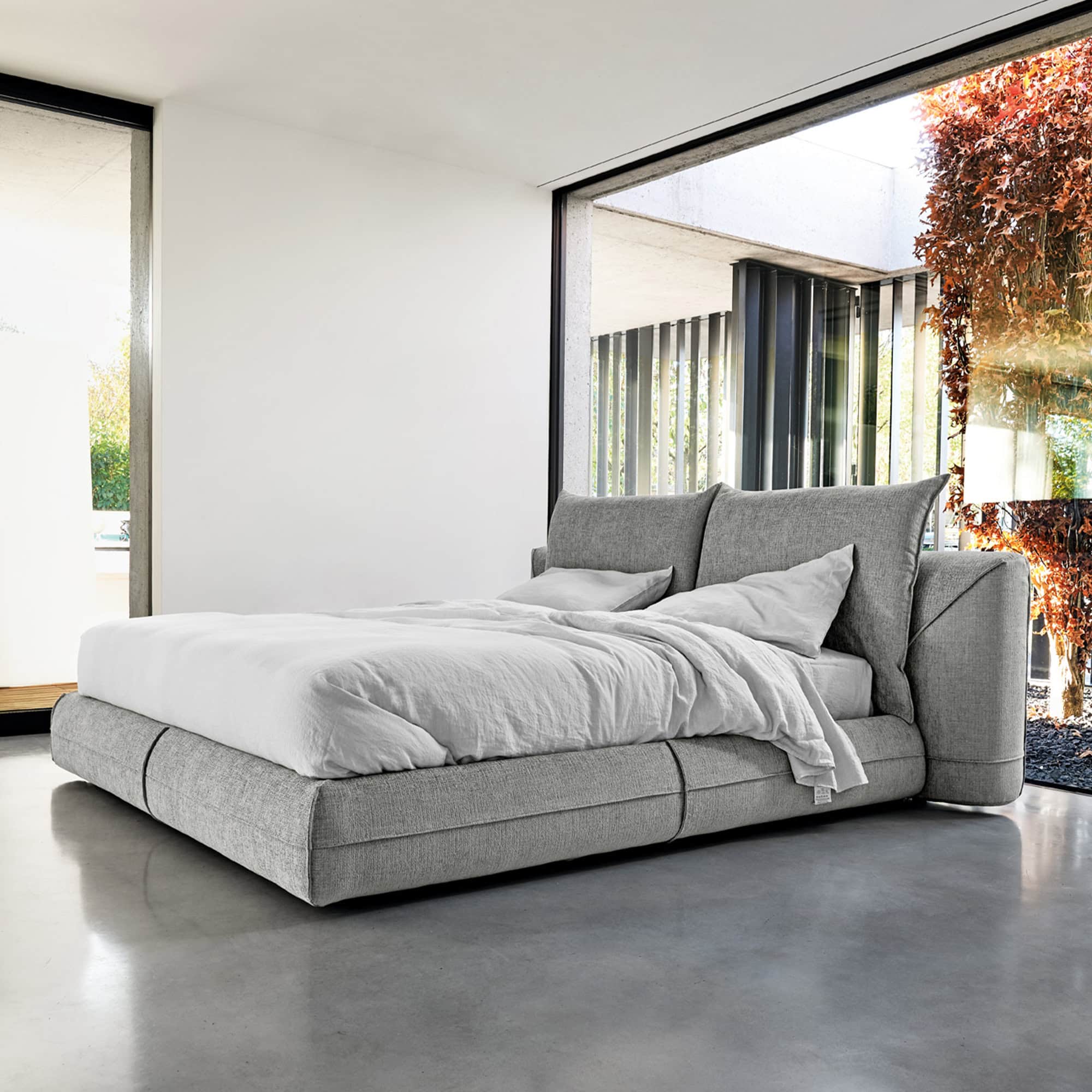 Starman Dream Bed with light fabric upholstery in a minimalist bedroom setting.