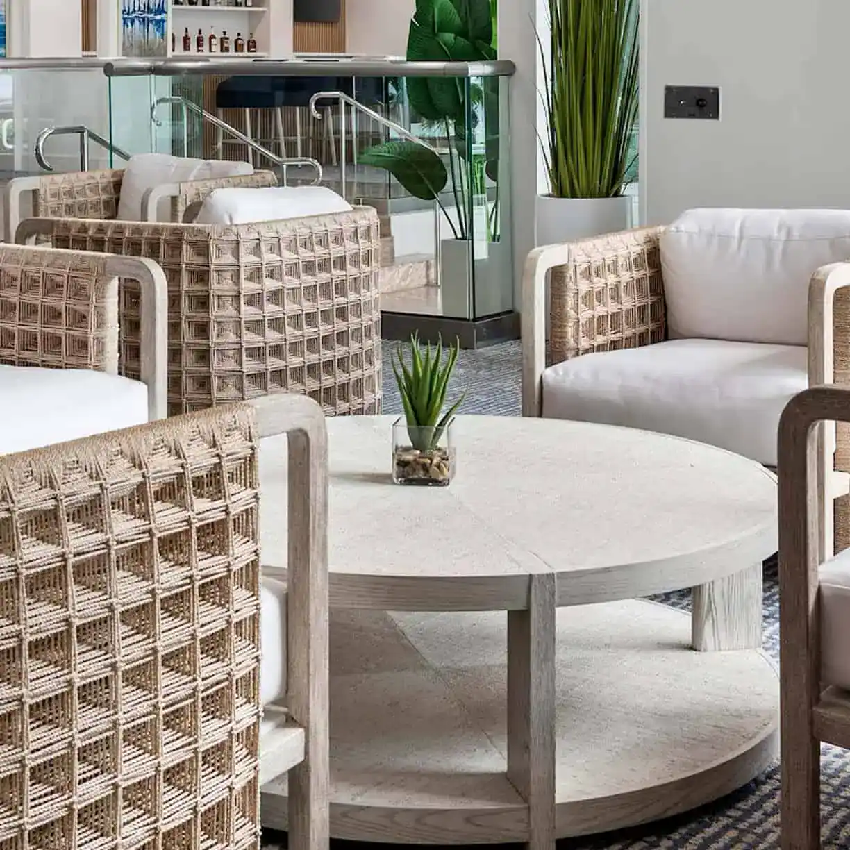 A Room With Wicker Furniture And A Table