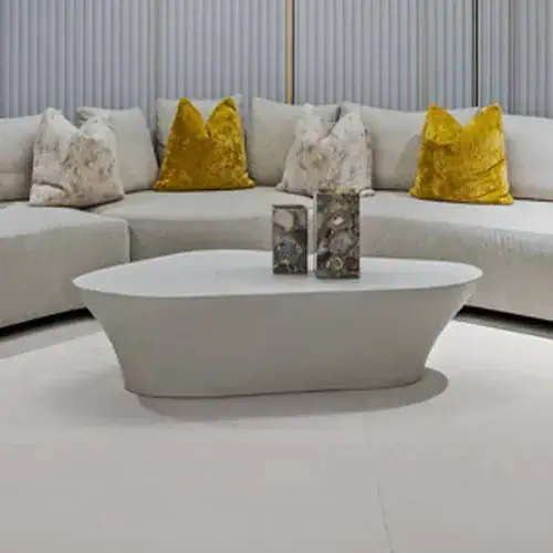 Contemporary oval coffee table with a decorative marble vase in a stylish living room setting.