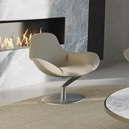 A modern beige swivel armchair in front of a marble fireplace with active flames, on a light rug, with a marble coffee table visible.