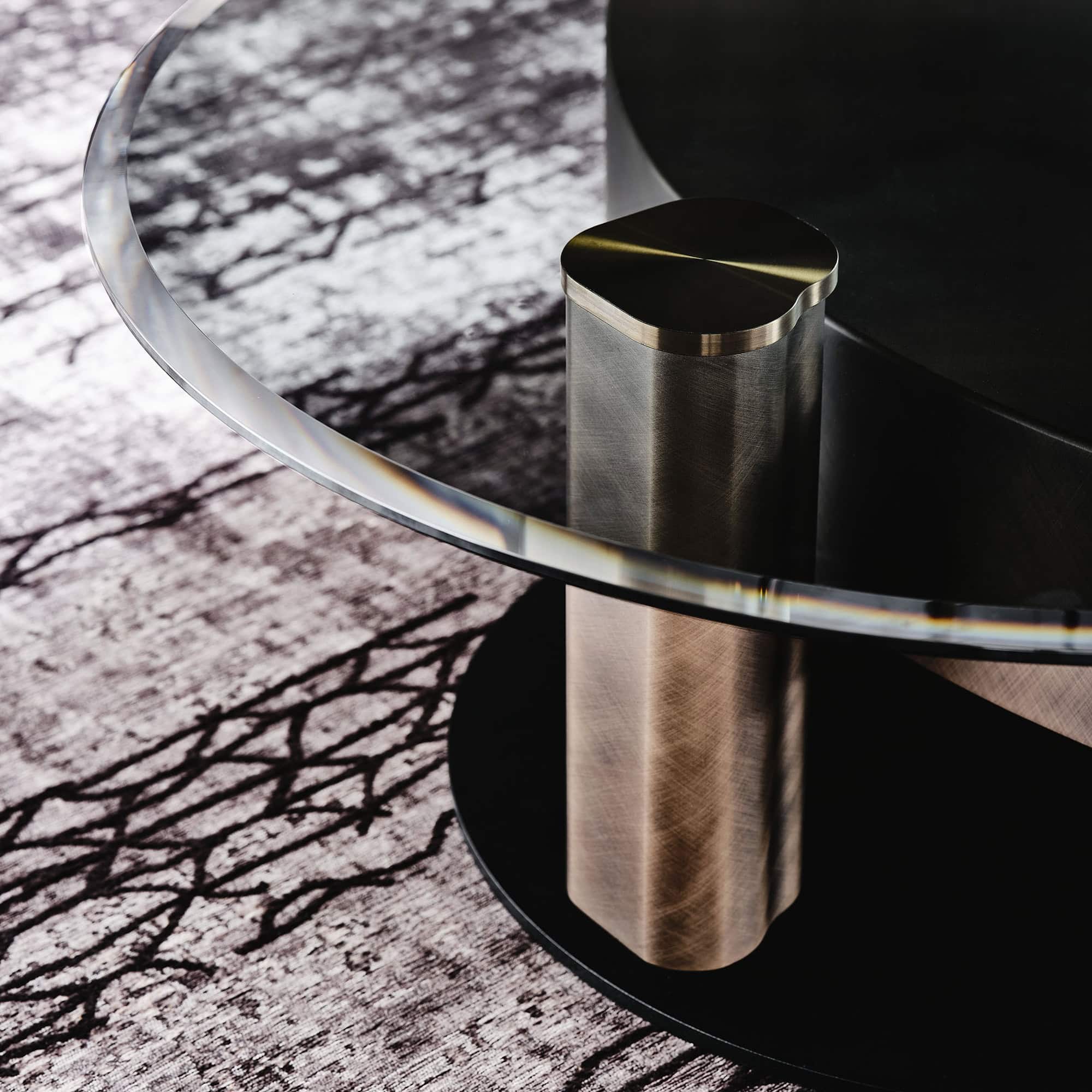 a glass table with a metal pole on top