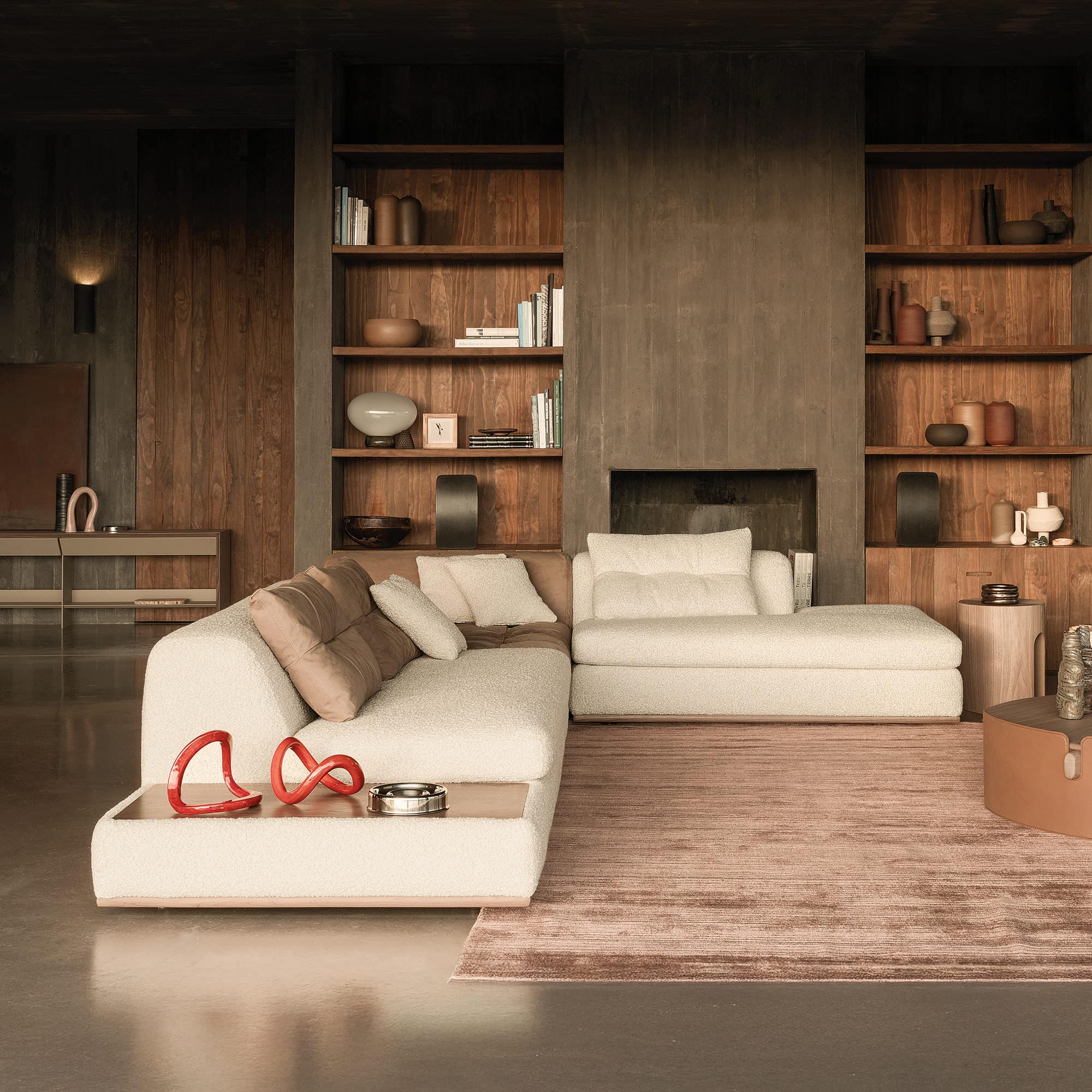 Sophisticated living room with modern white sectional sofa and wooden wall shelving by Sklar Furnishings.