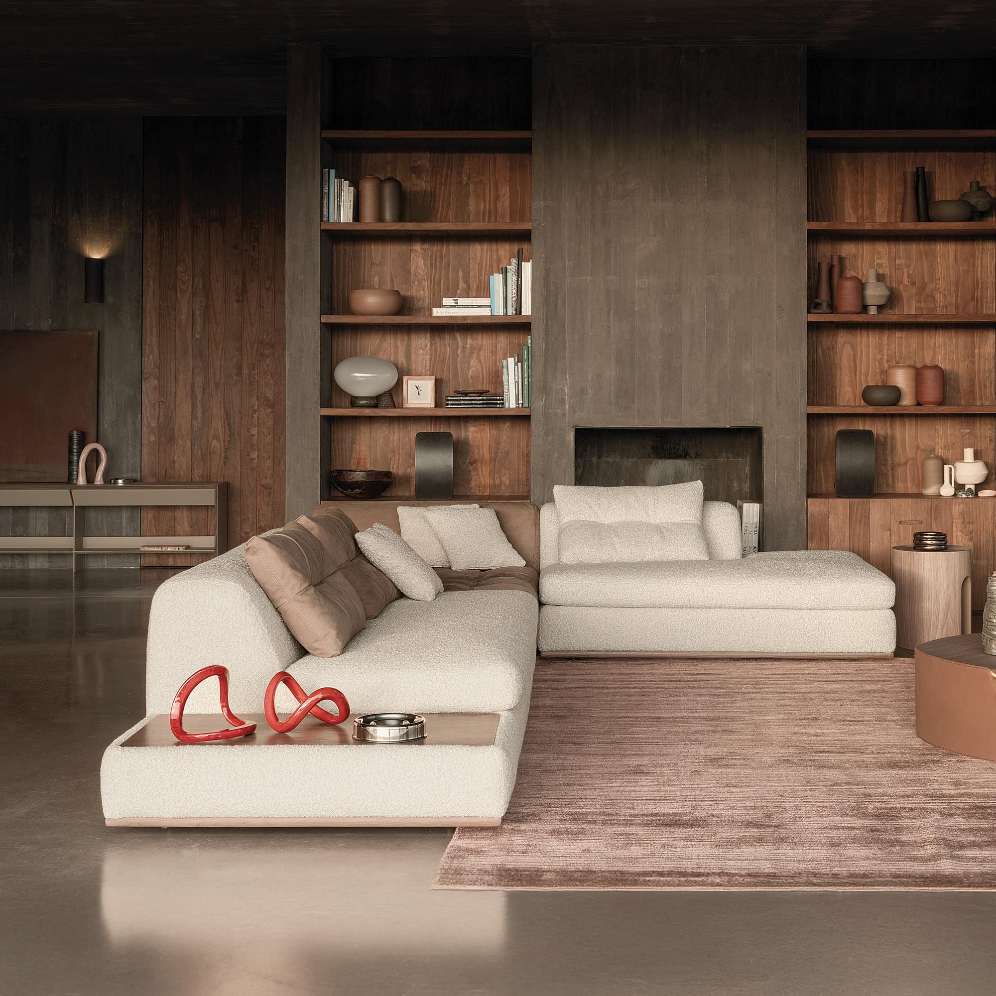 Sophisticated living room with modern white sectional sofa and wooden wall shelving by Sklar Furnishings.