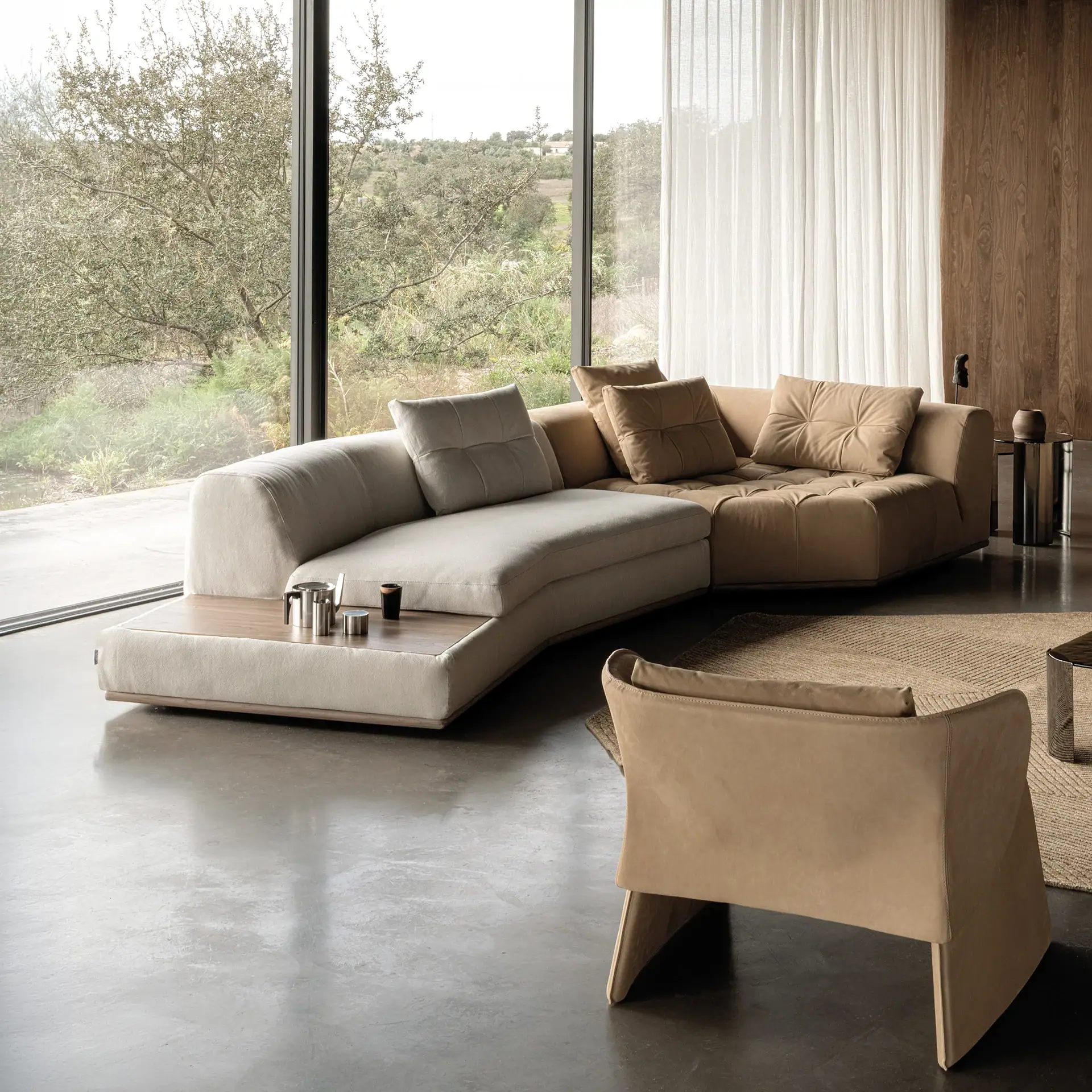 Sophisticated living room with modern white sectional sofa and wooden wall shelving by Sklar Furnishings.
