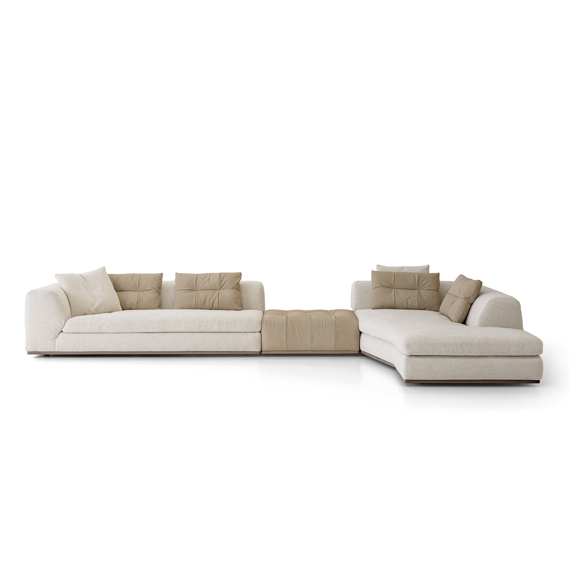 Side view of Montgomery Sofa with neutral fabric upholstery and accent pillows against a wood-paneled wall