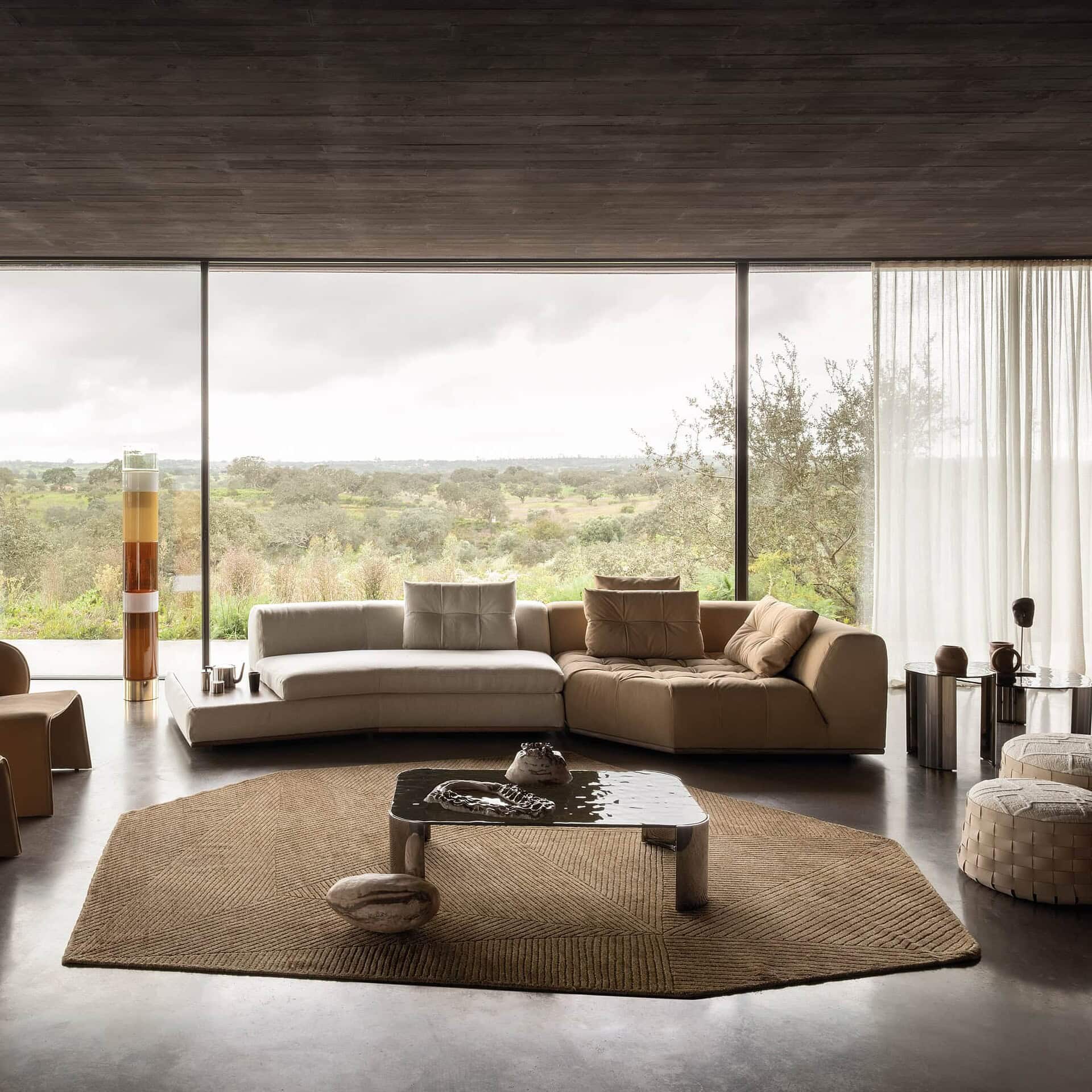 Montgomery Sectional Sofa styled with neutral cushions and brown accents in a sunlit room