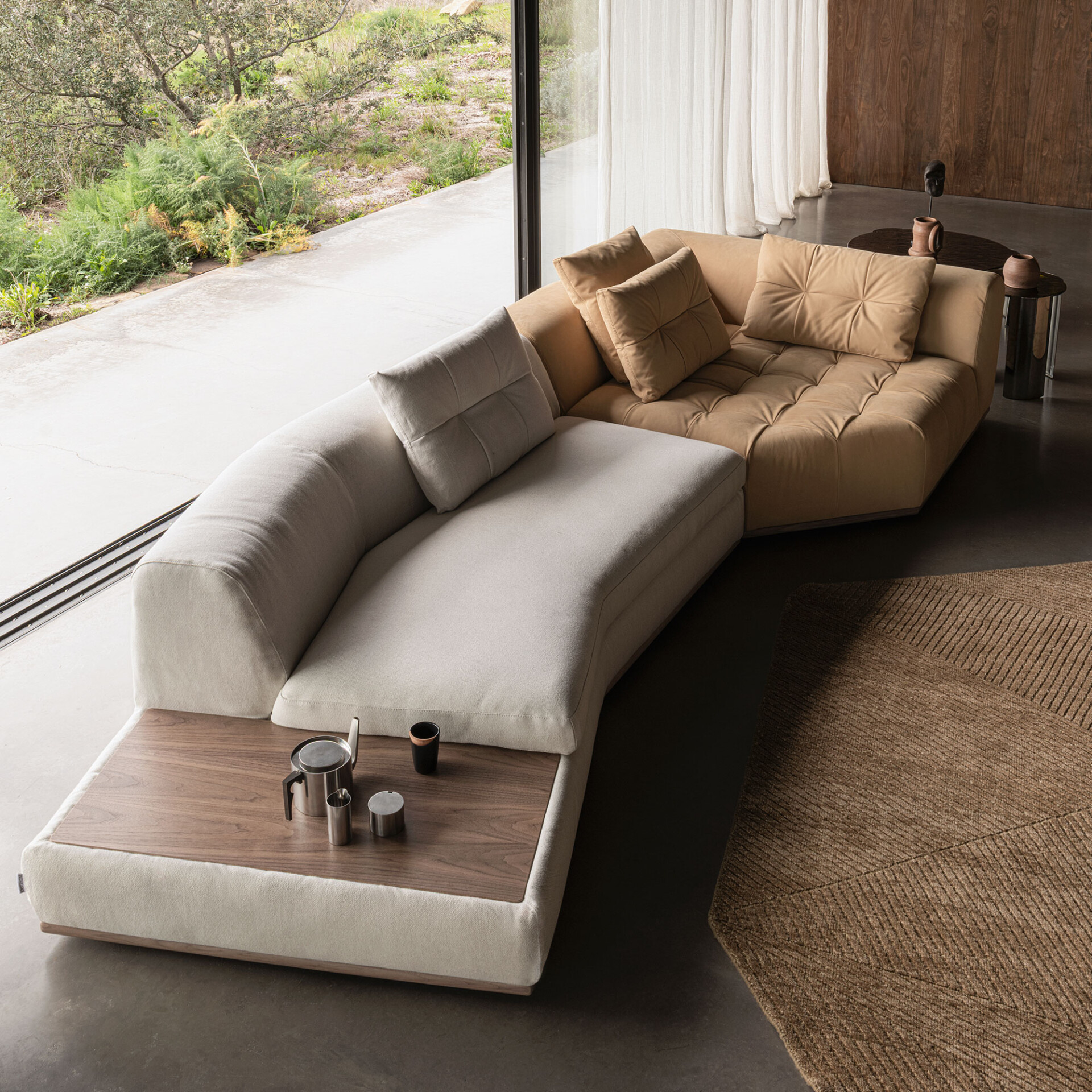 Angled view of Montgomery Sofa with extended chaise and integrated wood side table