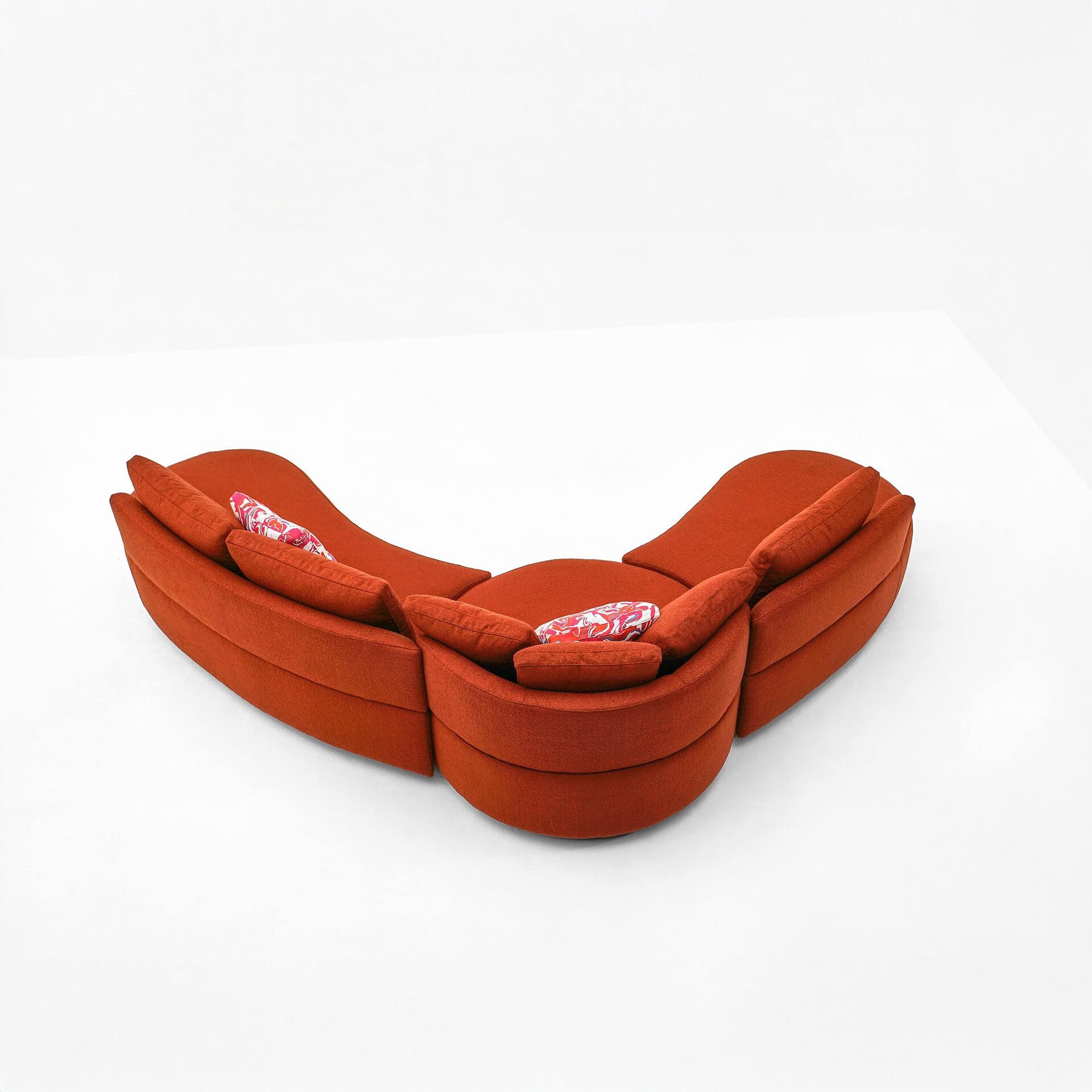 Back of Jean Sectional in red fabric, showcasing its flowing curved silhouette and modular design.