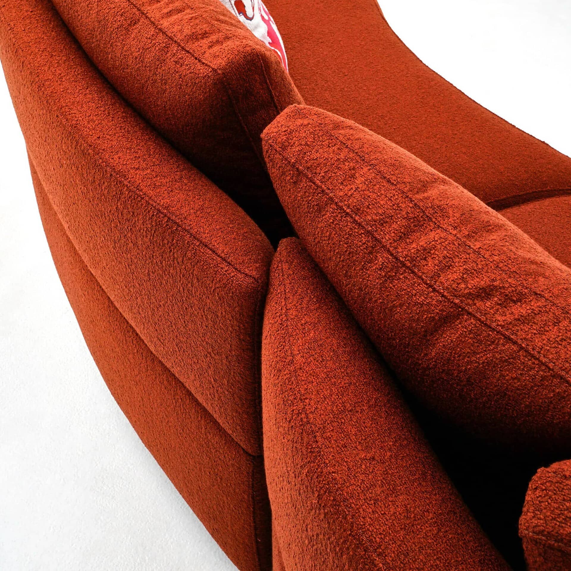 Close-up of Jean Sectional in rich red fabric highlighting plush cushions and textured upholstery.