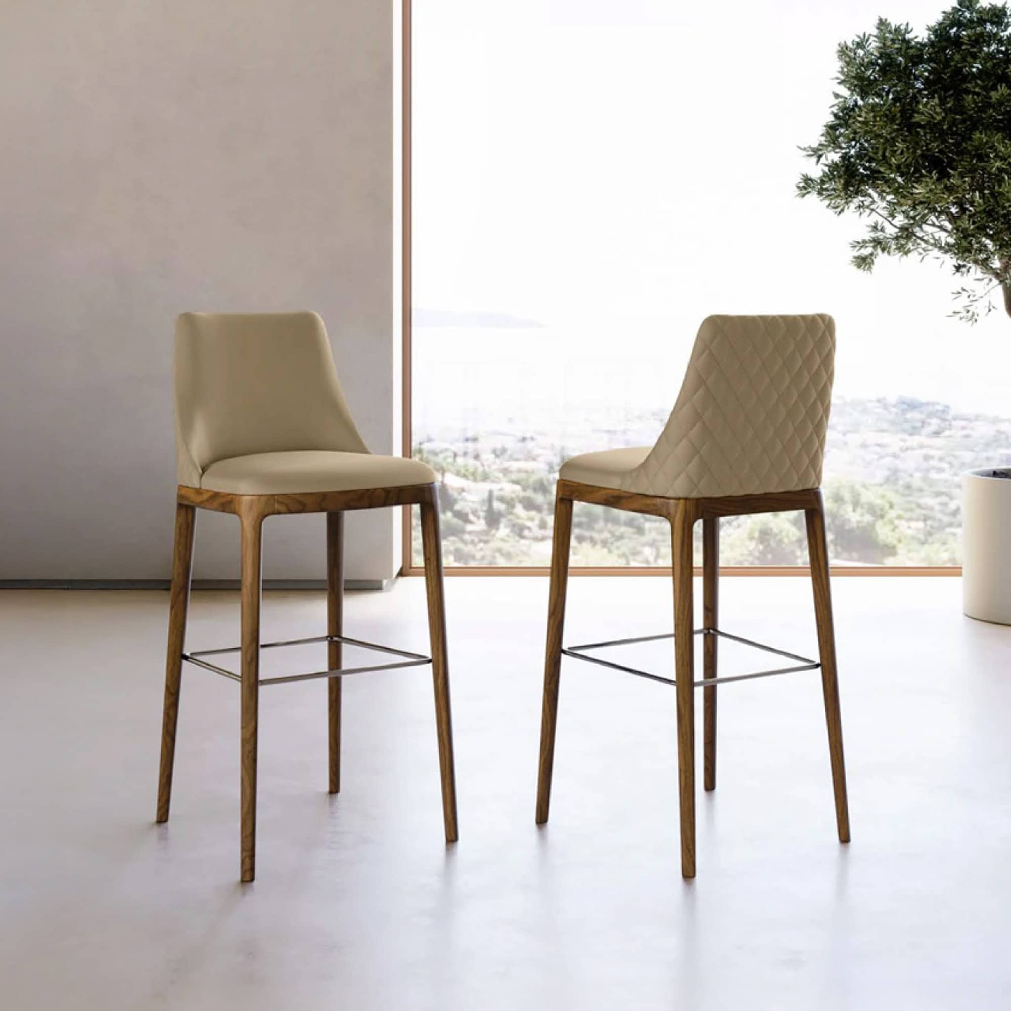 Modern high-back upholstered bar stools with wooden legs for contemporary dining spaces.