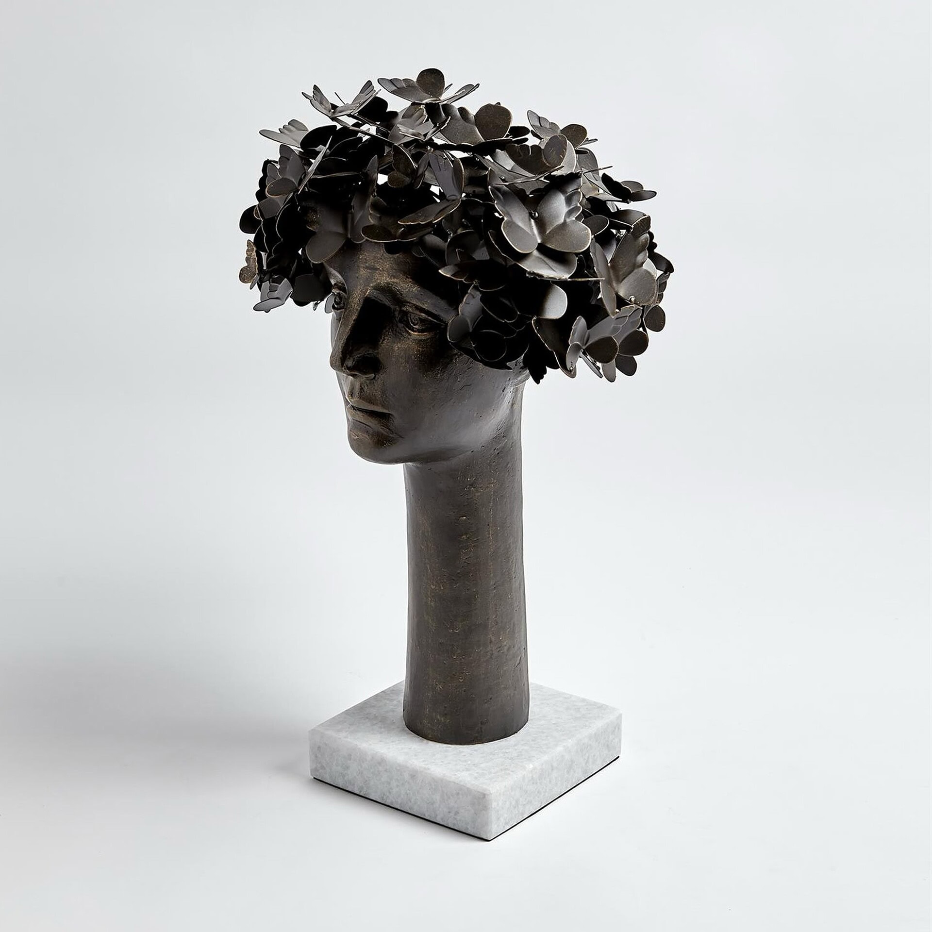 a sculpture of a head with flowers on it