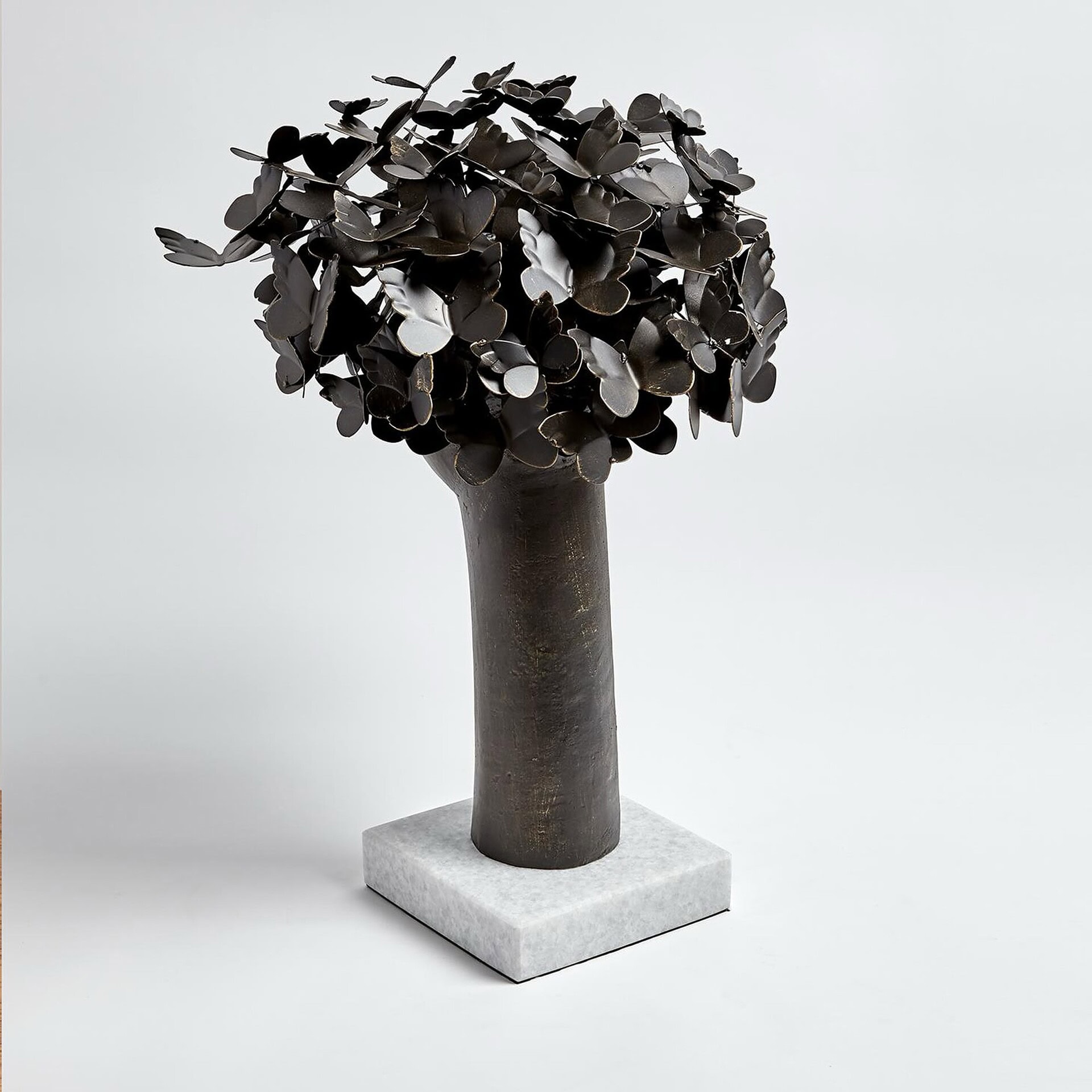 a tree with butterflies on top