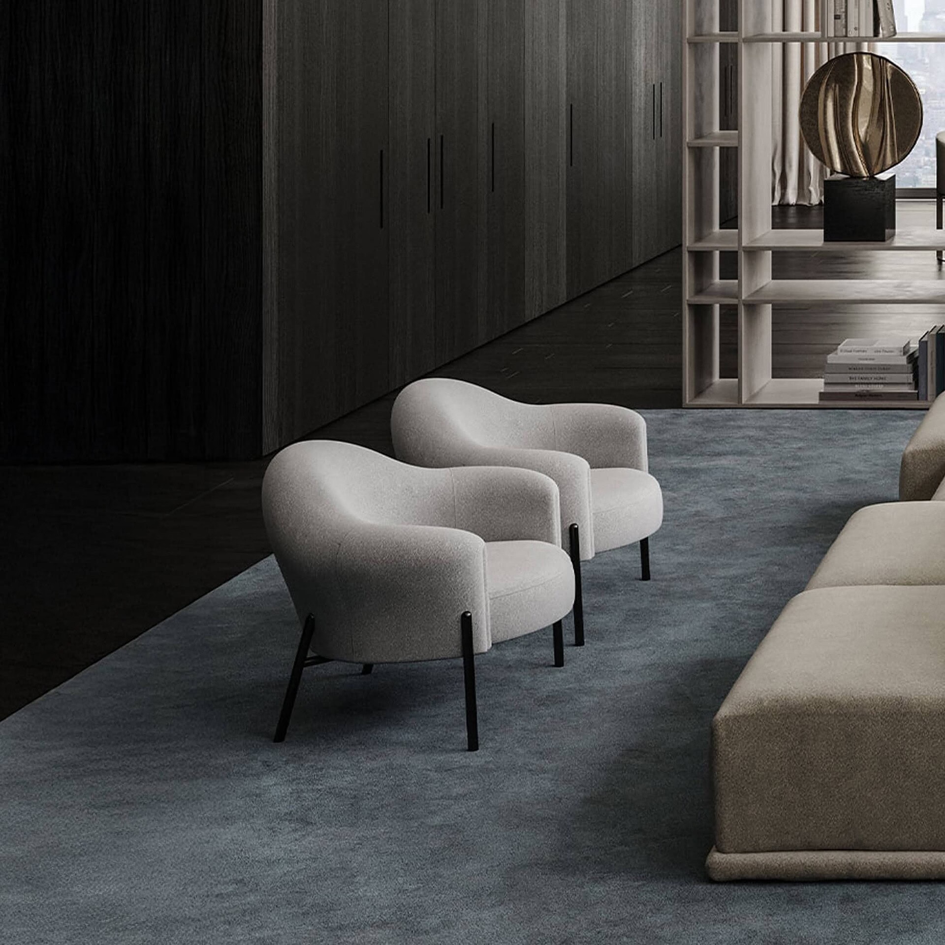 Quentin Upholstered Armchairs in a modern lounge, upholstered in cream fabric with wooden base.