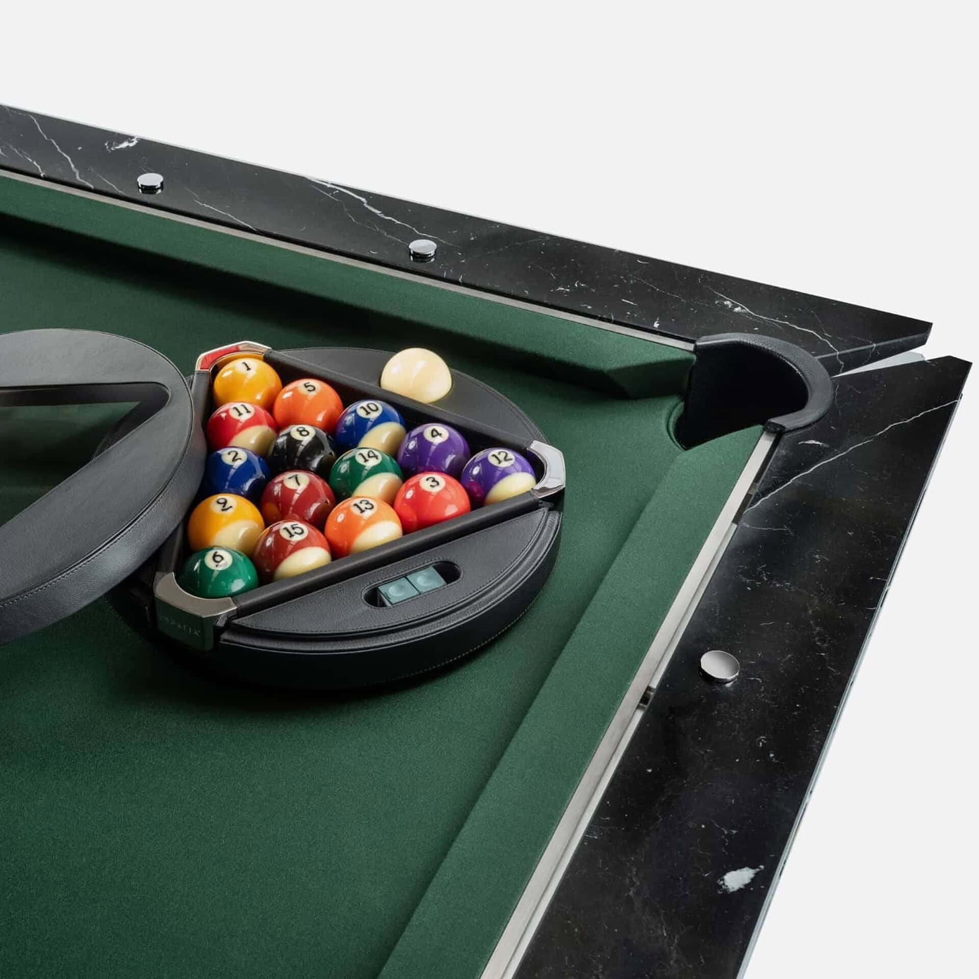 1. Custom pool table with black marble accents and green felt for elegant game rooms.