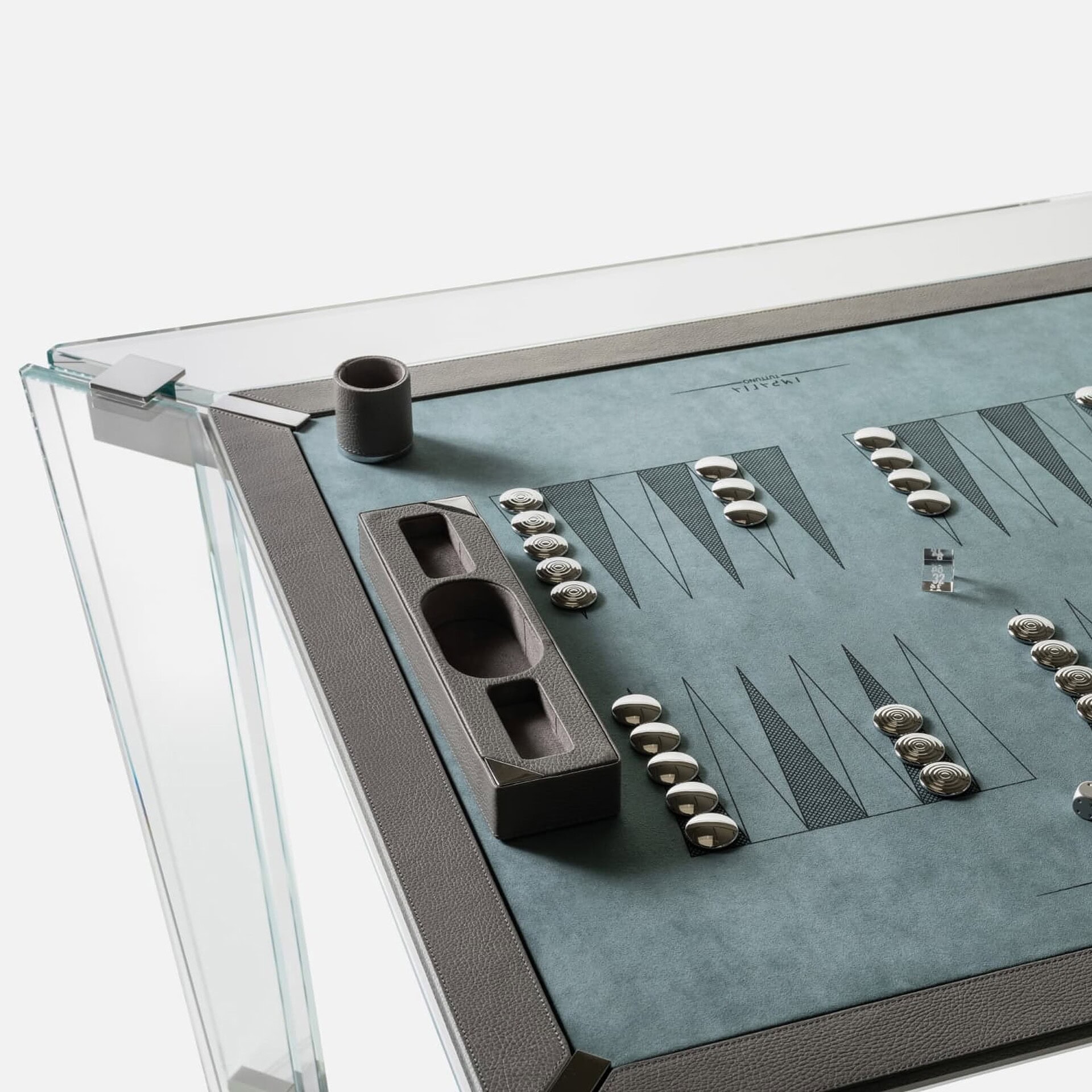 Leather and glass backgammon game table with metallic checkers and contemporary design.
