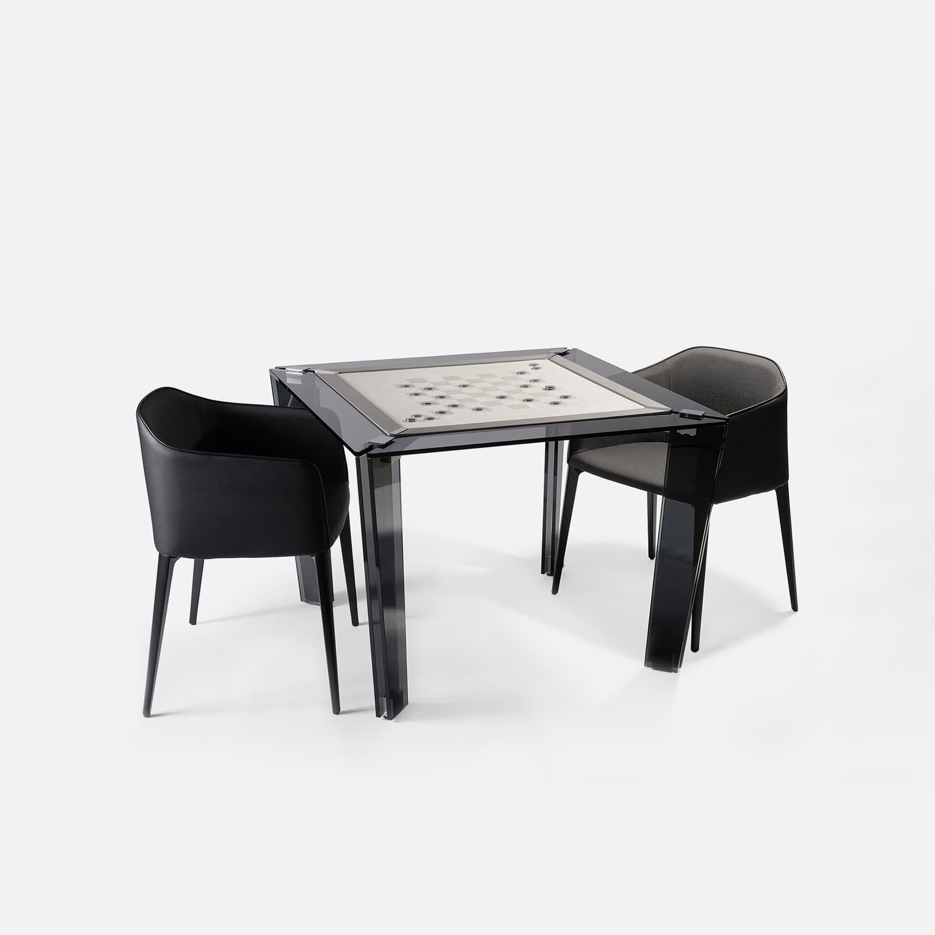 Sleek modern black glass chess table with two stylish black and gray chairs, perfect for contemporary living spaces.