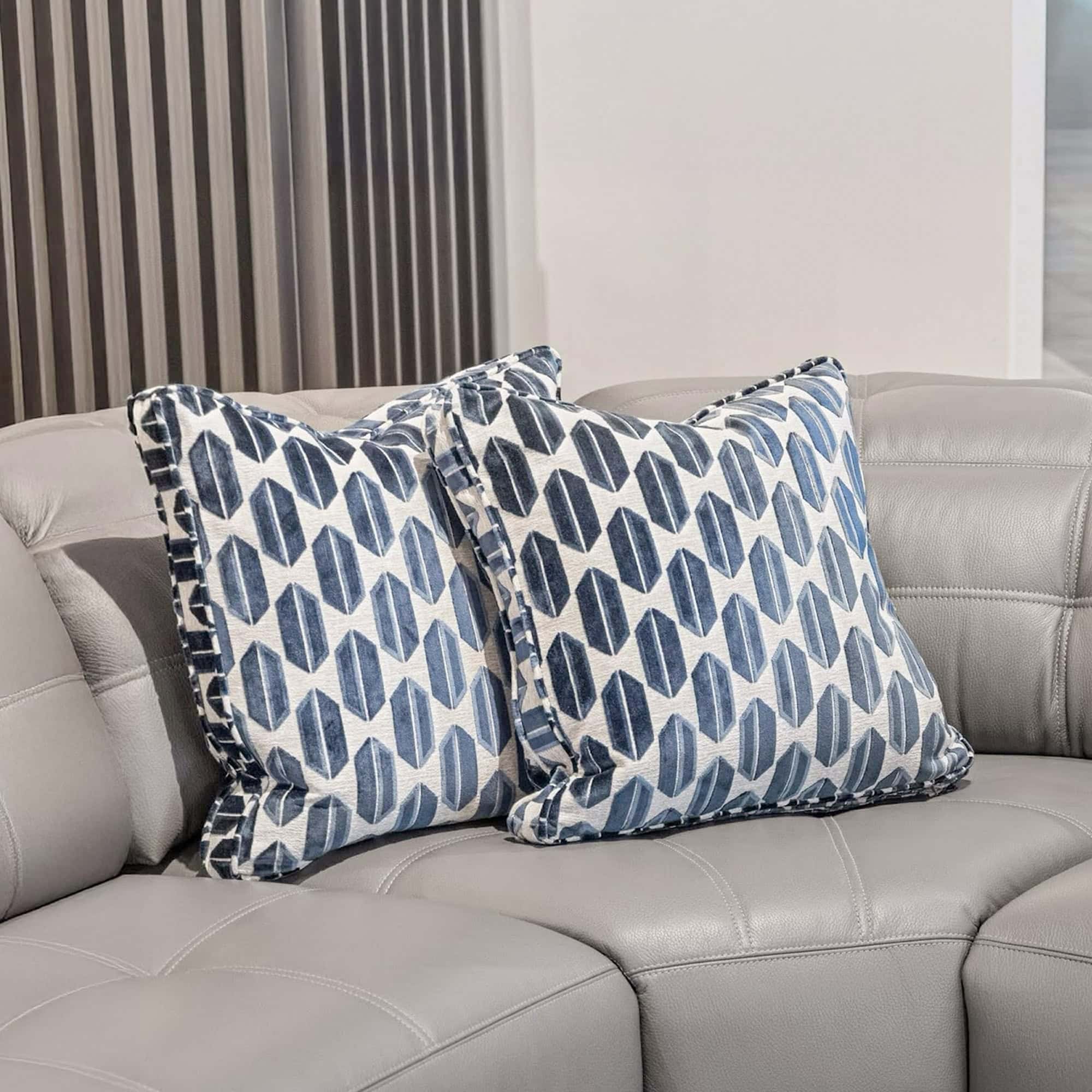 Blue patterned custom throw pillows on grey sectional sofa