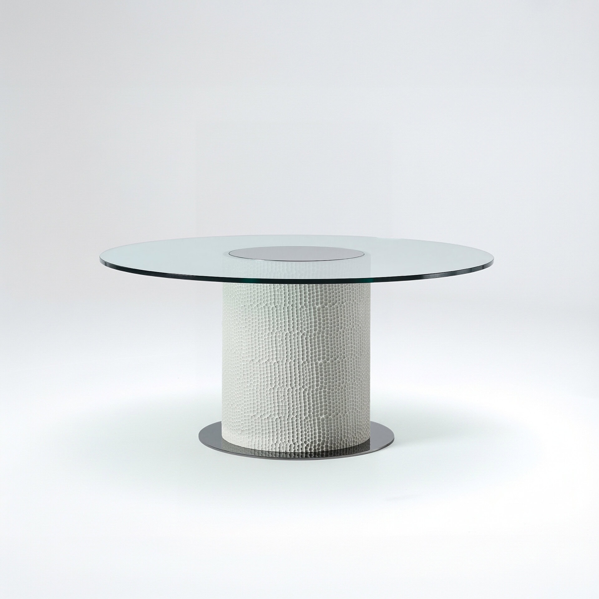 Modern Sahara round glass dining table with textured base, perfect for contemporary dining rooms.