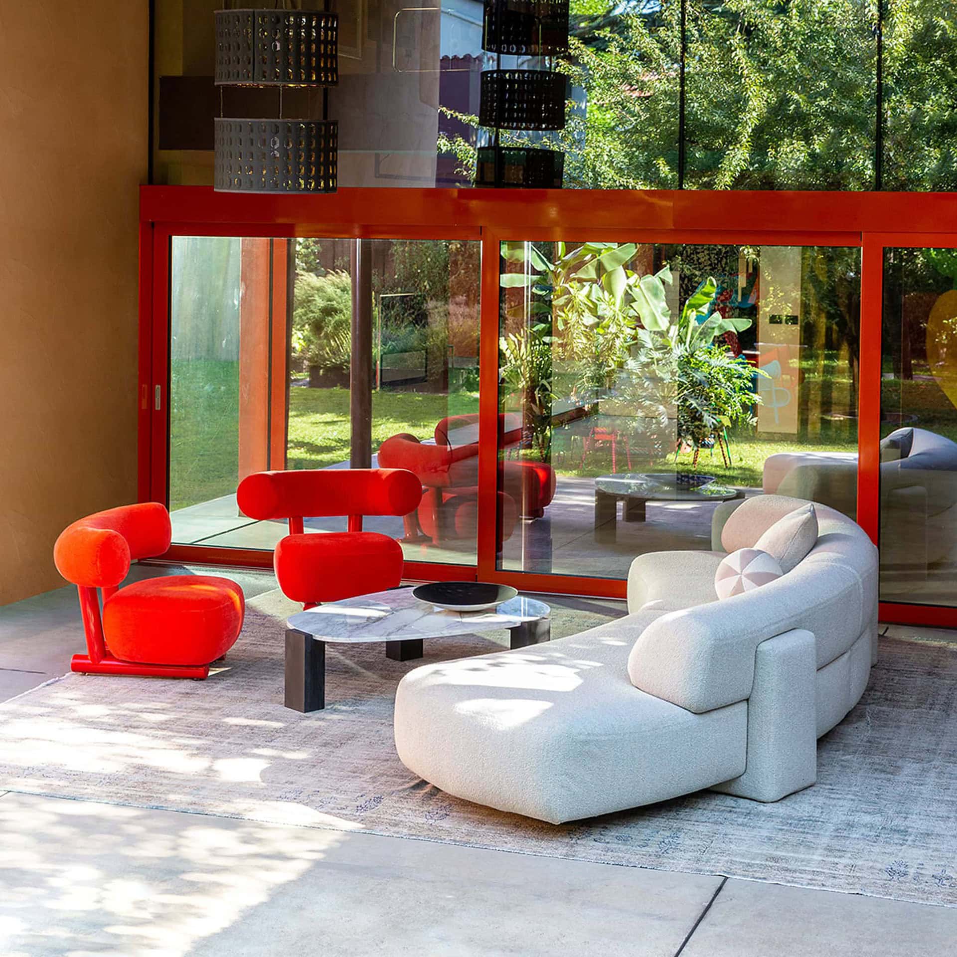 Light-colored Gogan Modular Curved Sofa styled in a warm-toned living room with modern accents.