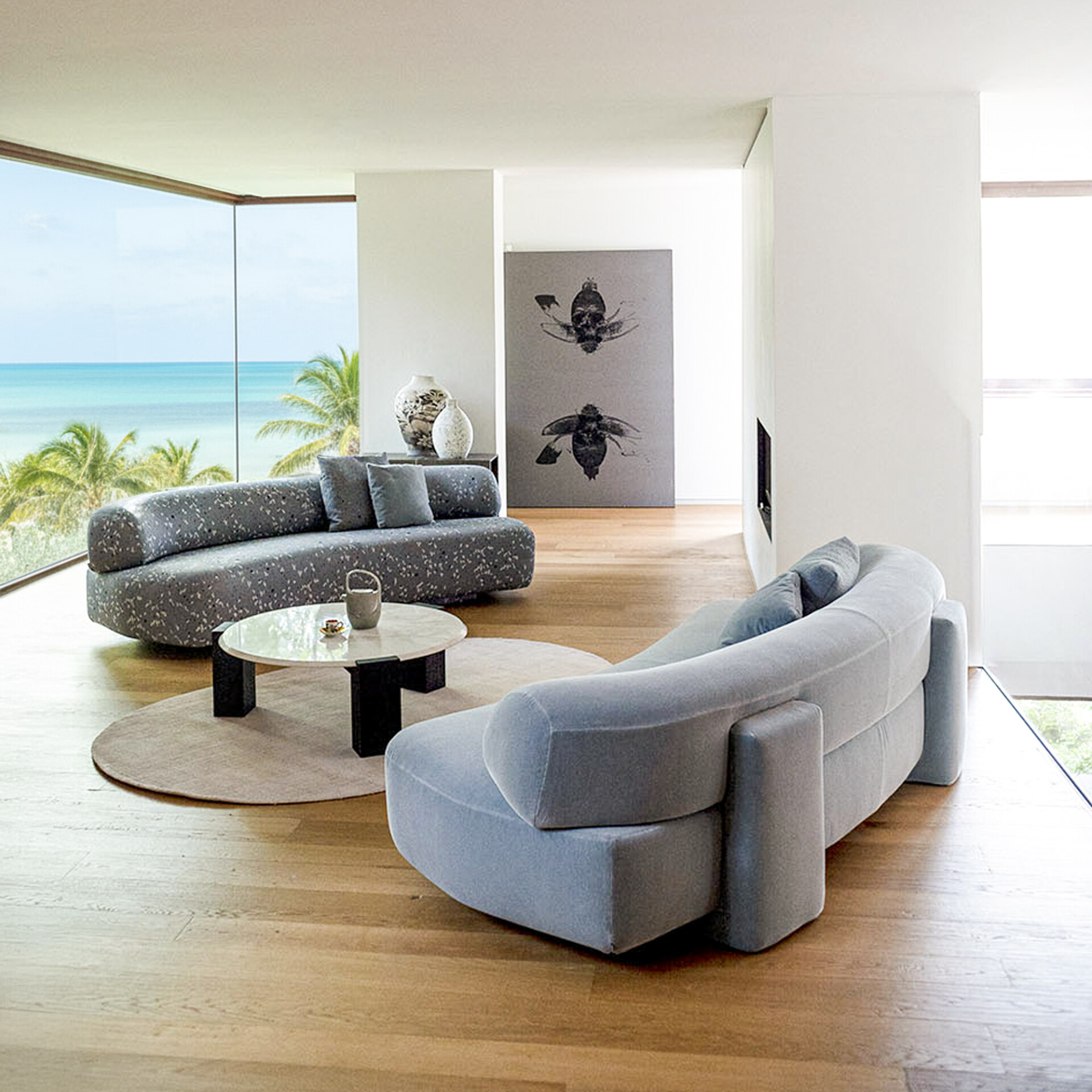 Gogan Modular Curved Sofa in a light fabric, shown in a modern living room with natural light.