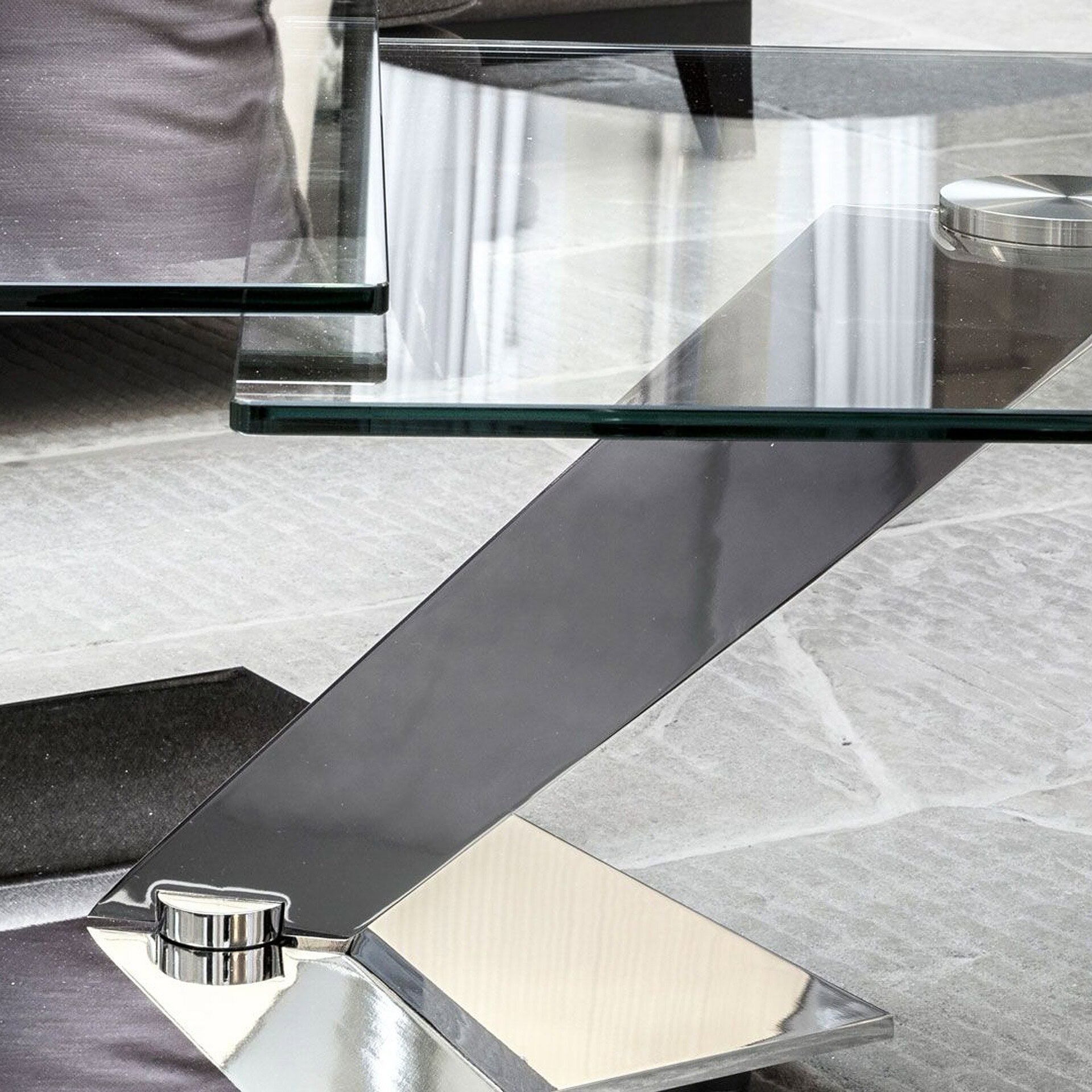 Modern glass table with sleek metal base in contemporary interior.