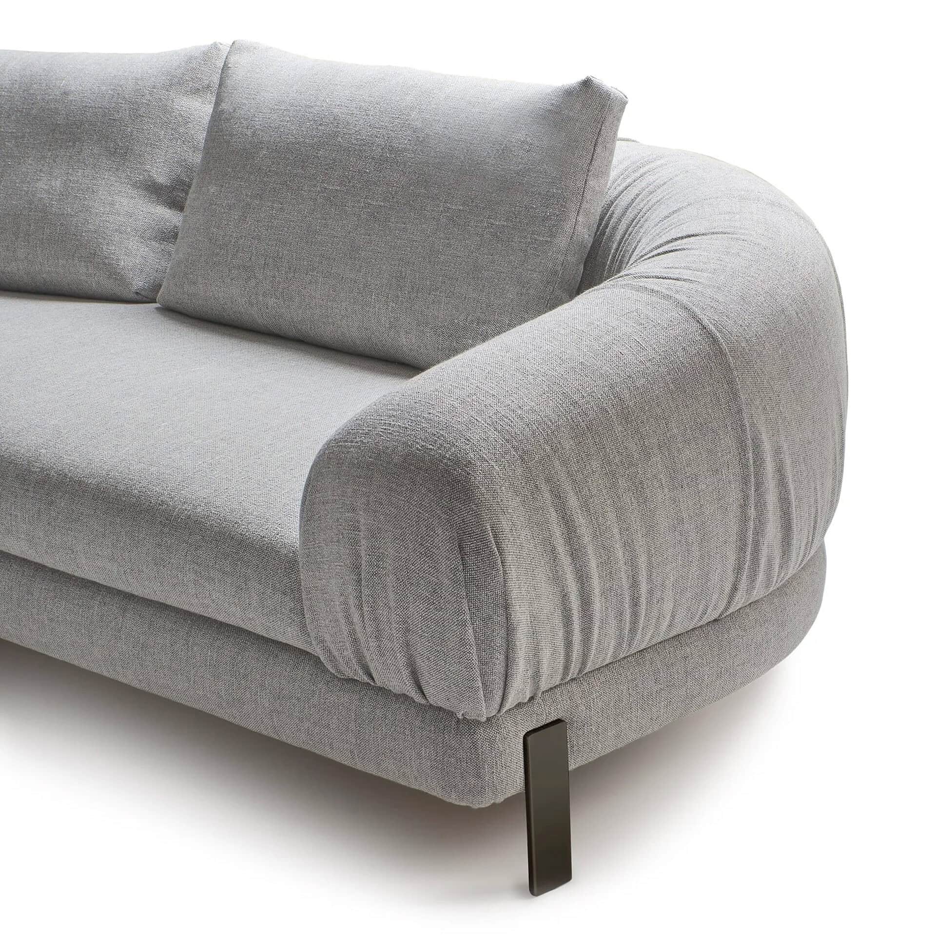 A modern light grey sofa with plush, rounded armrests and textured fabric, featuring a dark metal leg, against a white background.