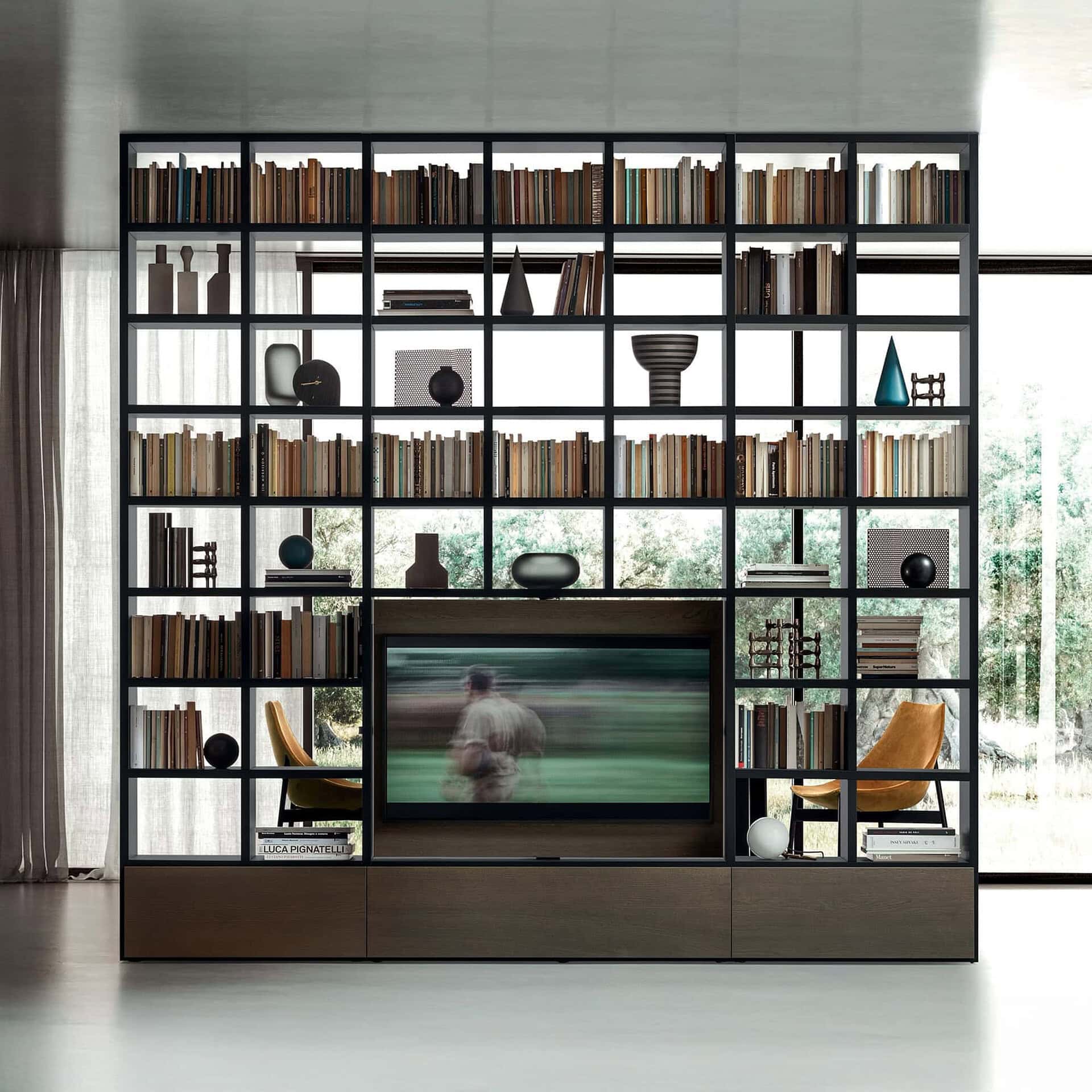 Black metal bookshelf with books, vases, and decor in a contemporary living space.