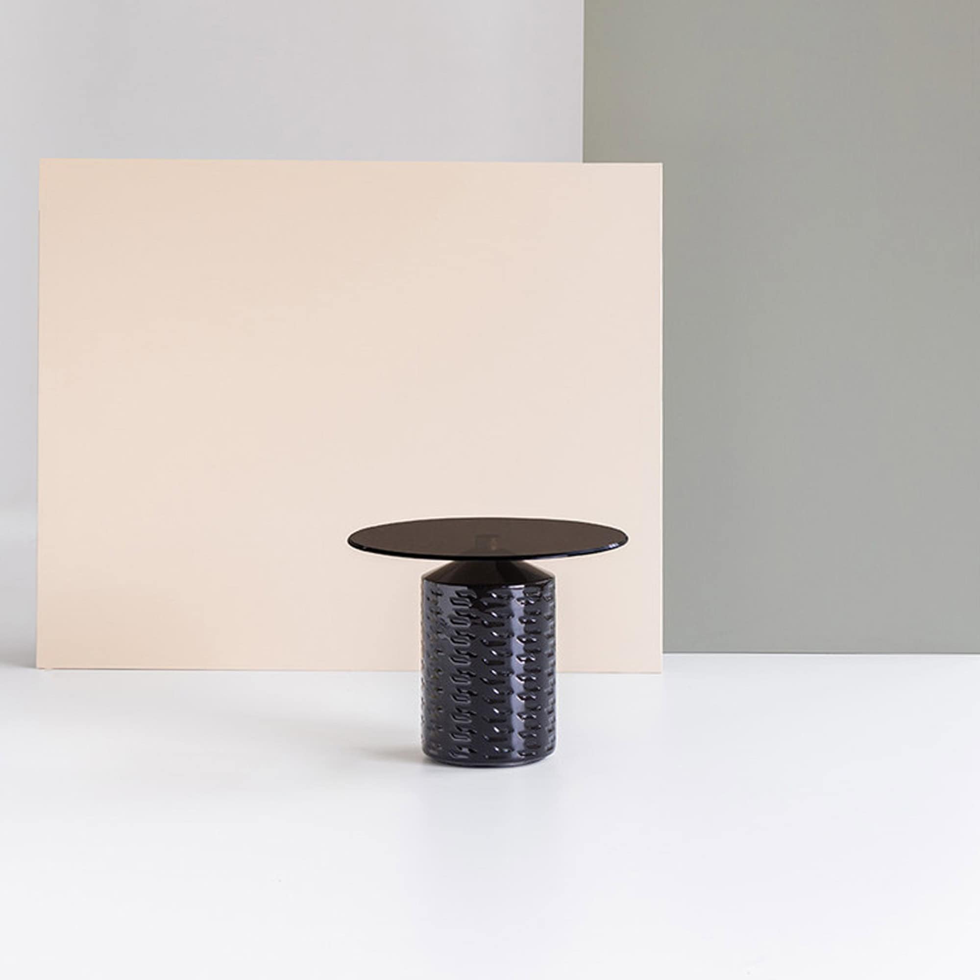 Sleek black modern side table with textured base and glossy finish, perfect for contemporary living spaces.