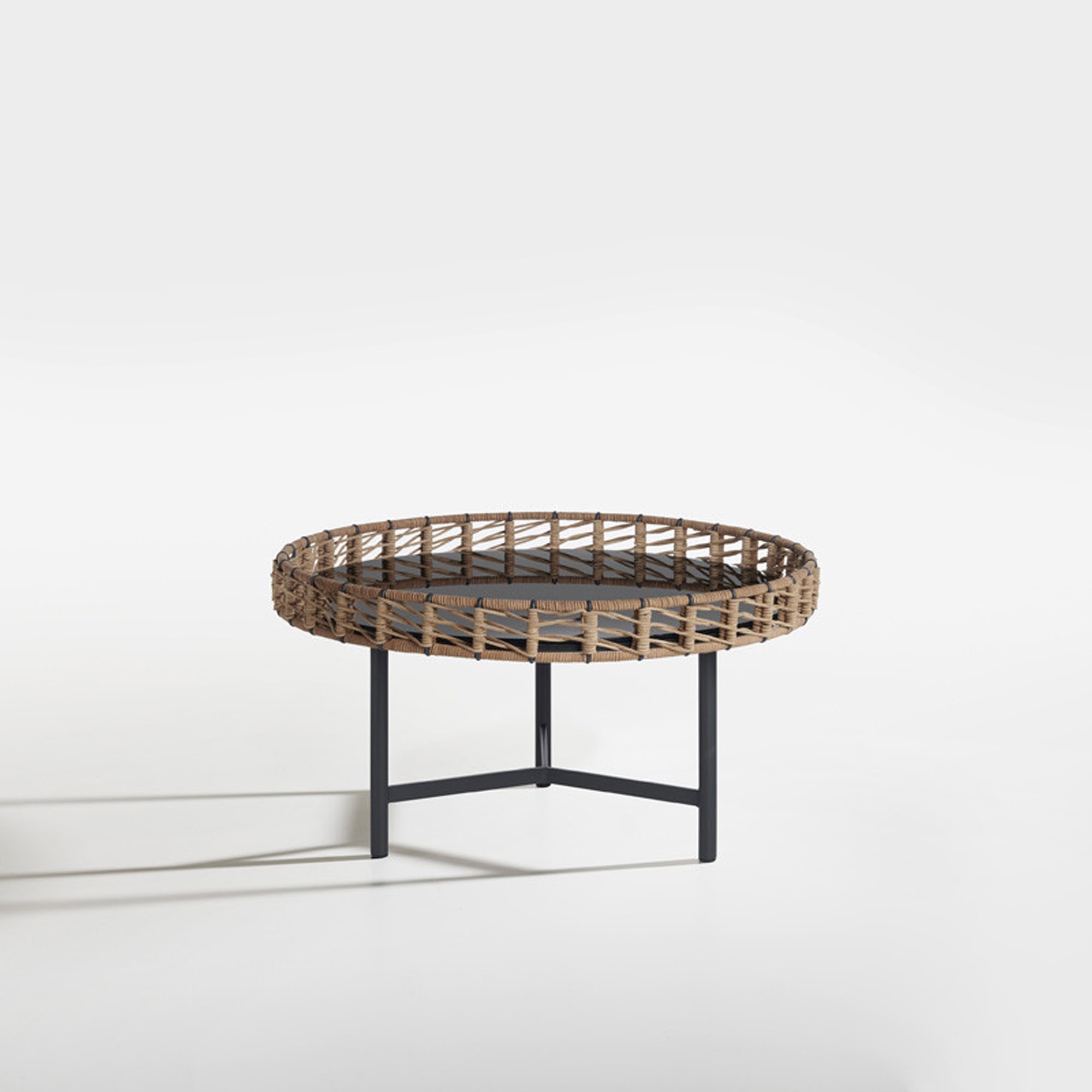 Stylish woven rattan coffee table with black metal legs, perfect for modern living spaces.