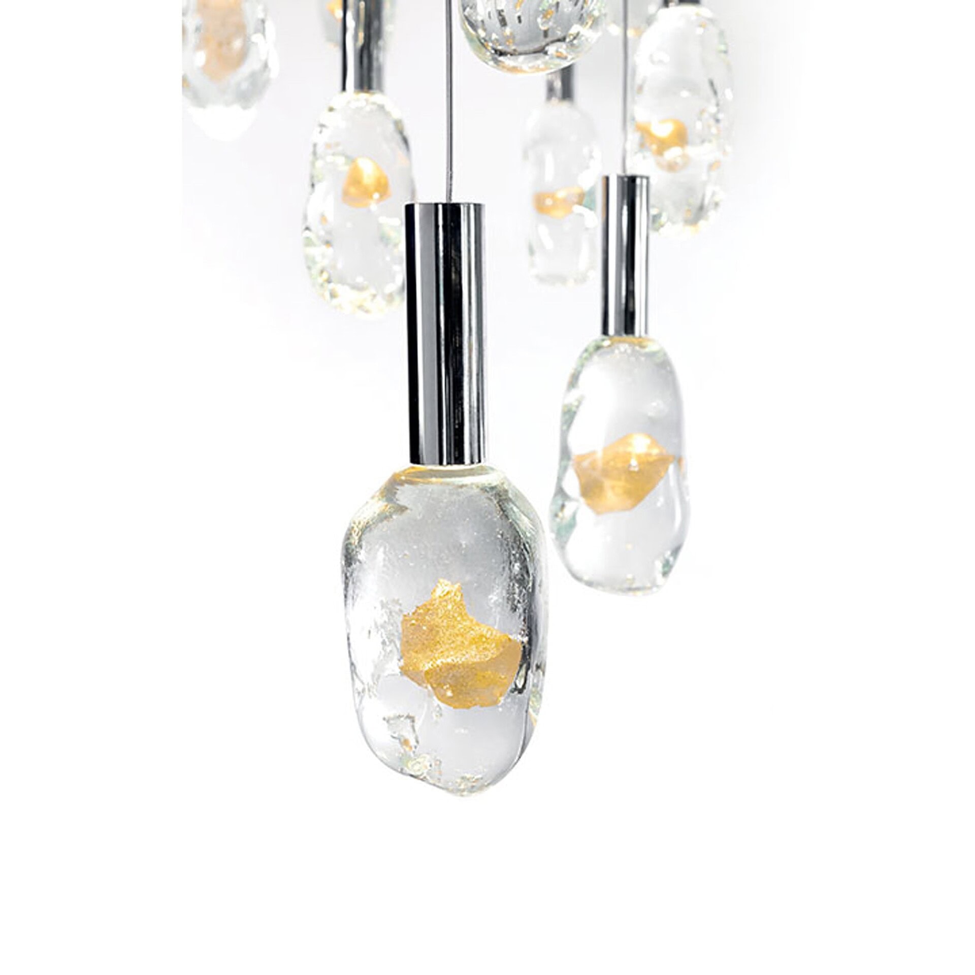 Detailed close-up of the Sassi Murano Glass chandelier pendants showing handcrafted transparent glass with embedded gold accents and chrome supports.