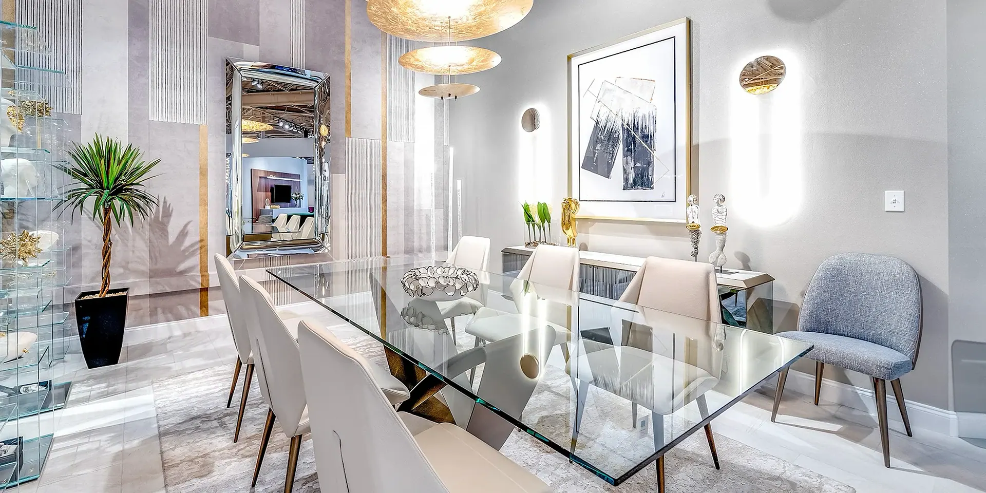 a dining room with a glass table and chairs