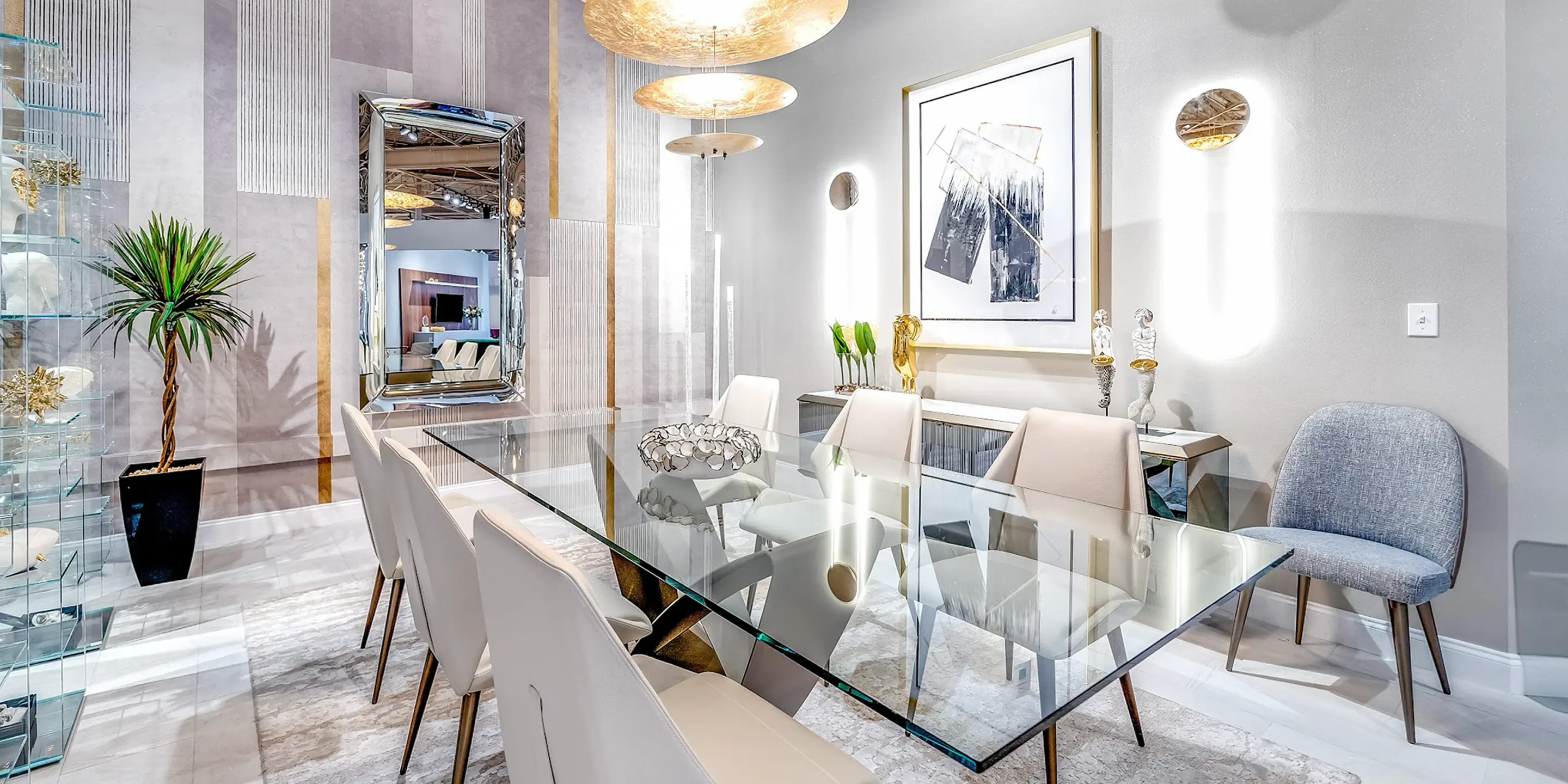 showroom-vignette-sep-23-dining-room a dining room with a glass table and chairs