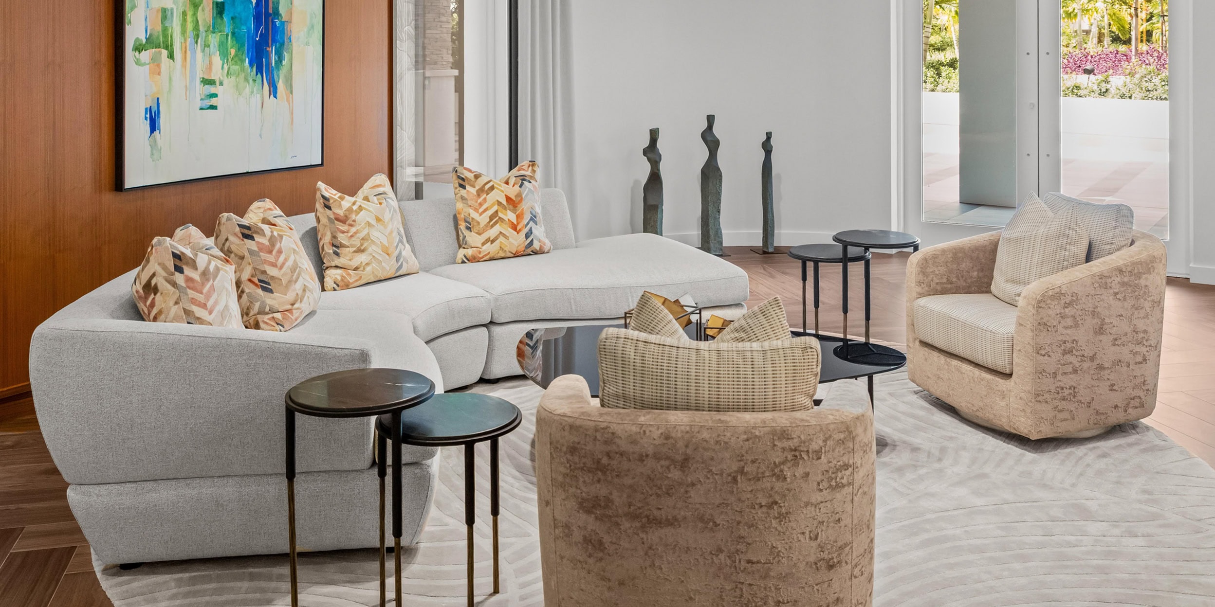 Contemporary beige sectional sofa with colorful throw pillows in a modern lounge setting.