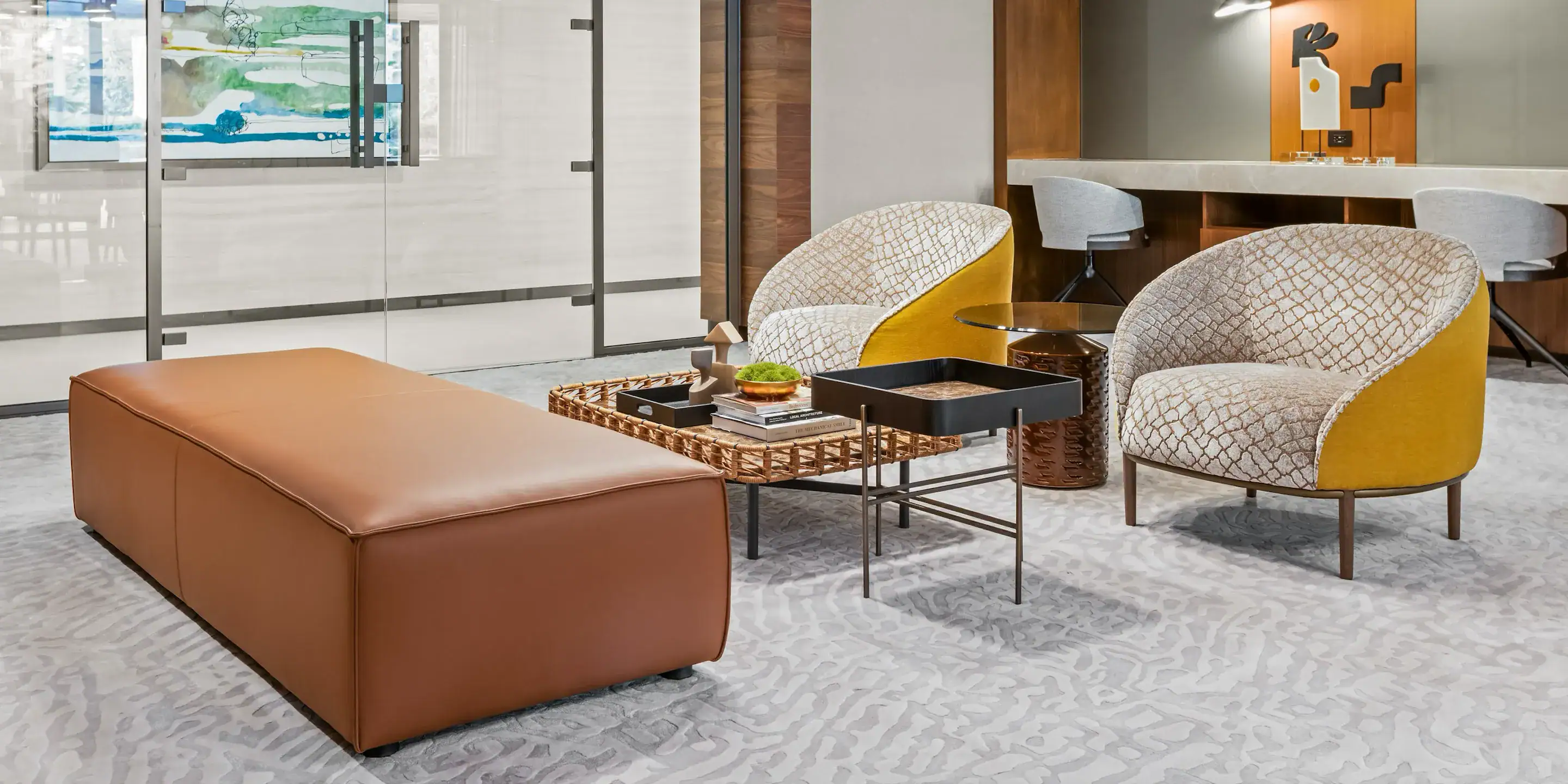 Stylish modern hotel lounge area with contemporary seating and decorative tables for relaxing or socializing.
